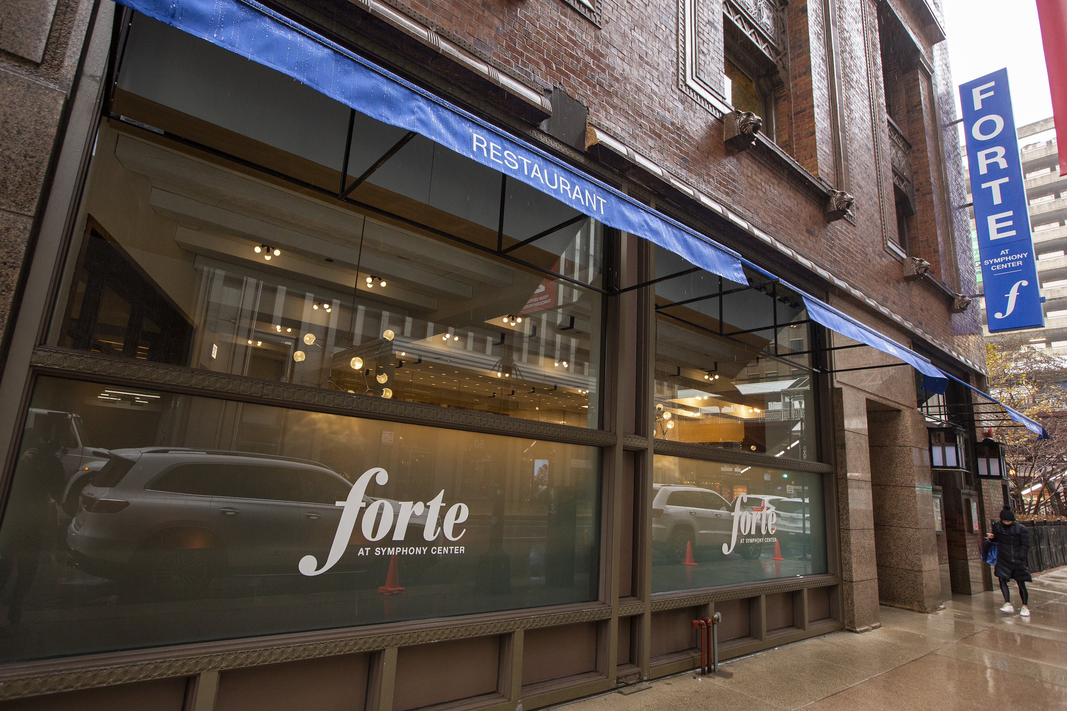 The exterior of a brick restaurant with large windows that read “Forte.”