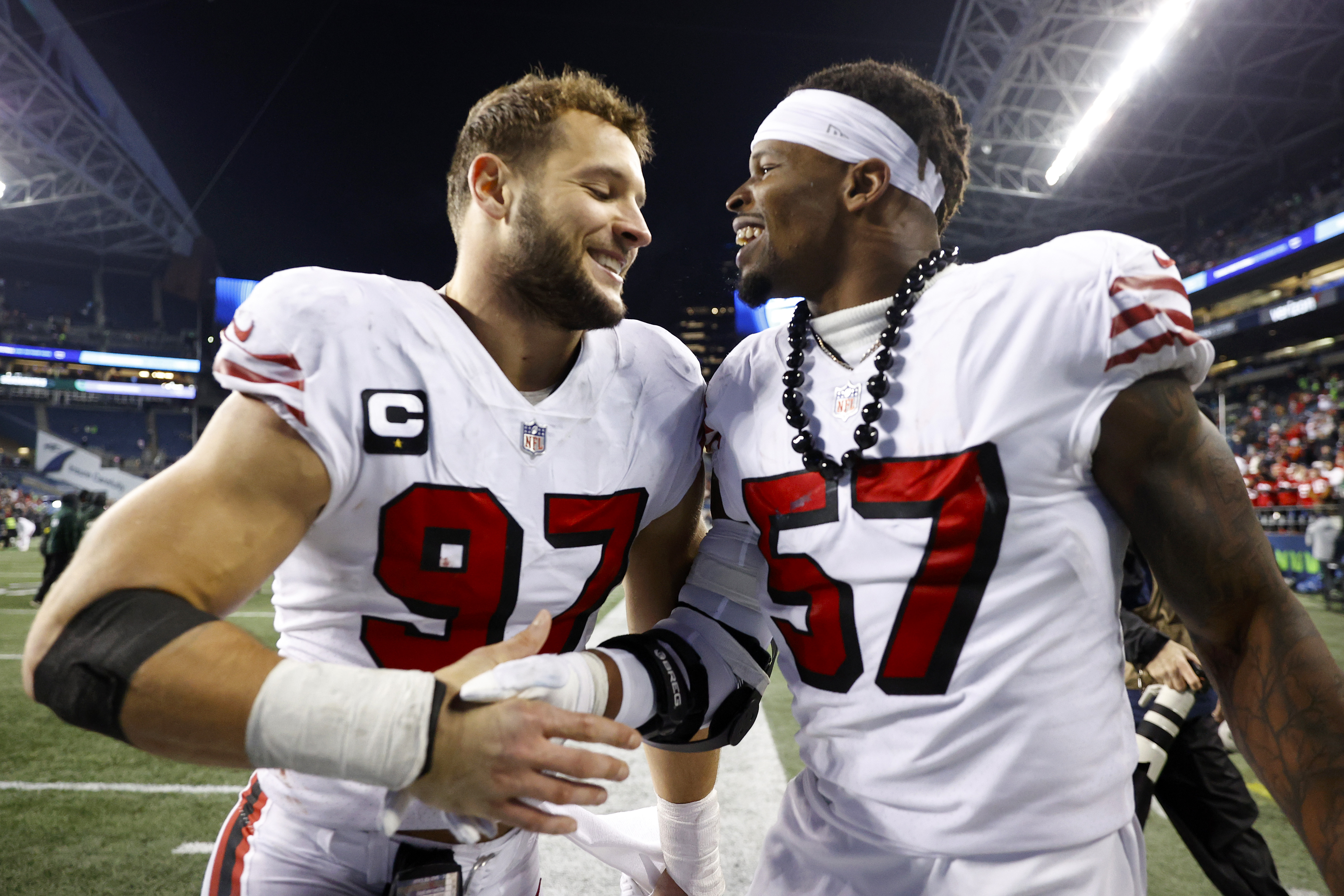 Nick Bosa #97 and Dre Greenlaw #57 of the San Francisco 49ers celebrate after defeating the Seattle Seahawks at Lumen Field on December 15, 2022 in Seattle, Washington.
