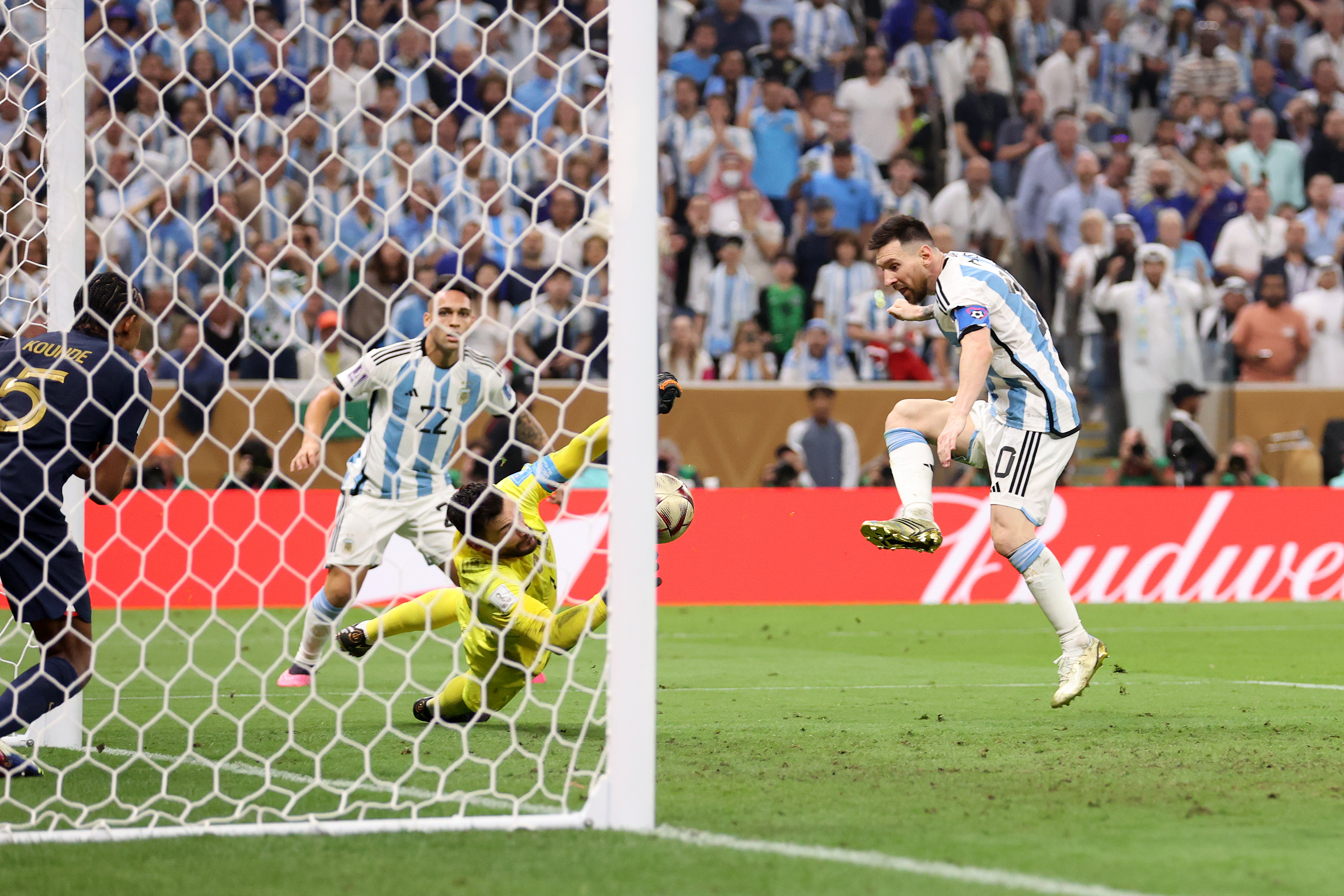 Lionel Messi of Argentina scores the team’s third goal past Hugo Lloris of France during the FIFA World Cup Qatar 2022 Final match between Argentina and France at Lusail Stadium on December 18, 2022 in Lusail City, Qatar.