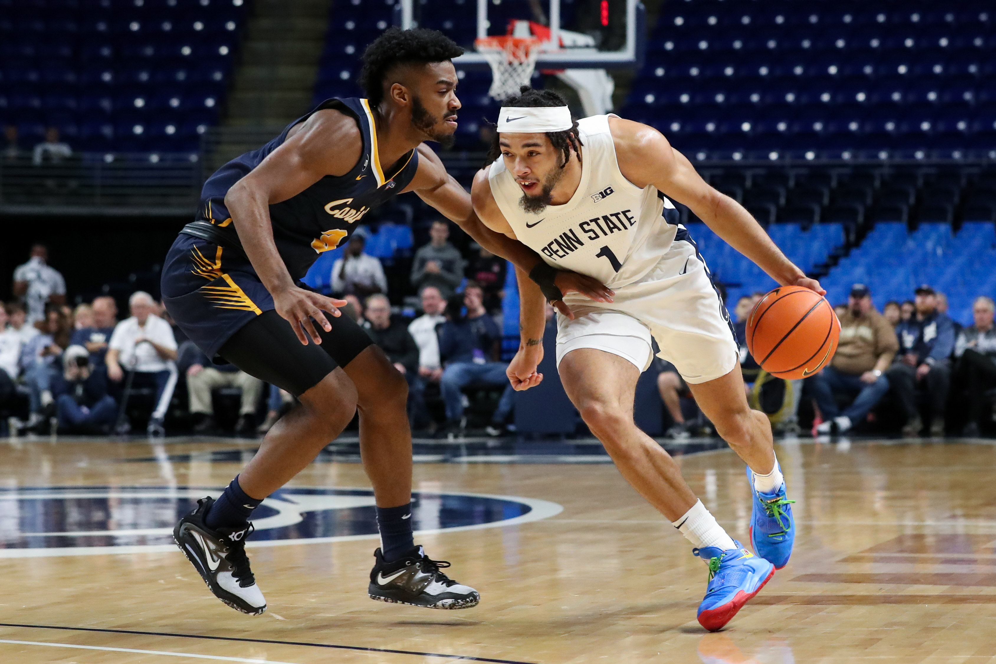 Dec 18, 2022; University Park, Pennsylvania, USA; Penn State Nittany Lions guard/forward Seth Lundy (1) dribbles the ball around the outside of Canisius Golden Griffins guard Jordan Henderson (3) during the first half at Bryce Jordan Center.