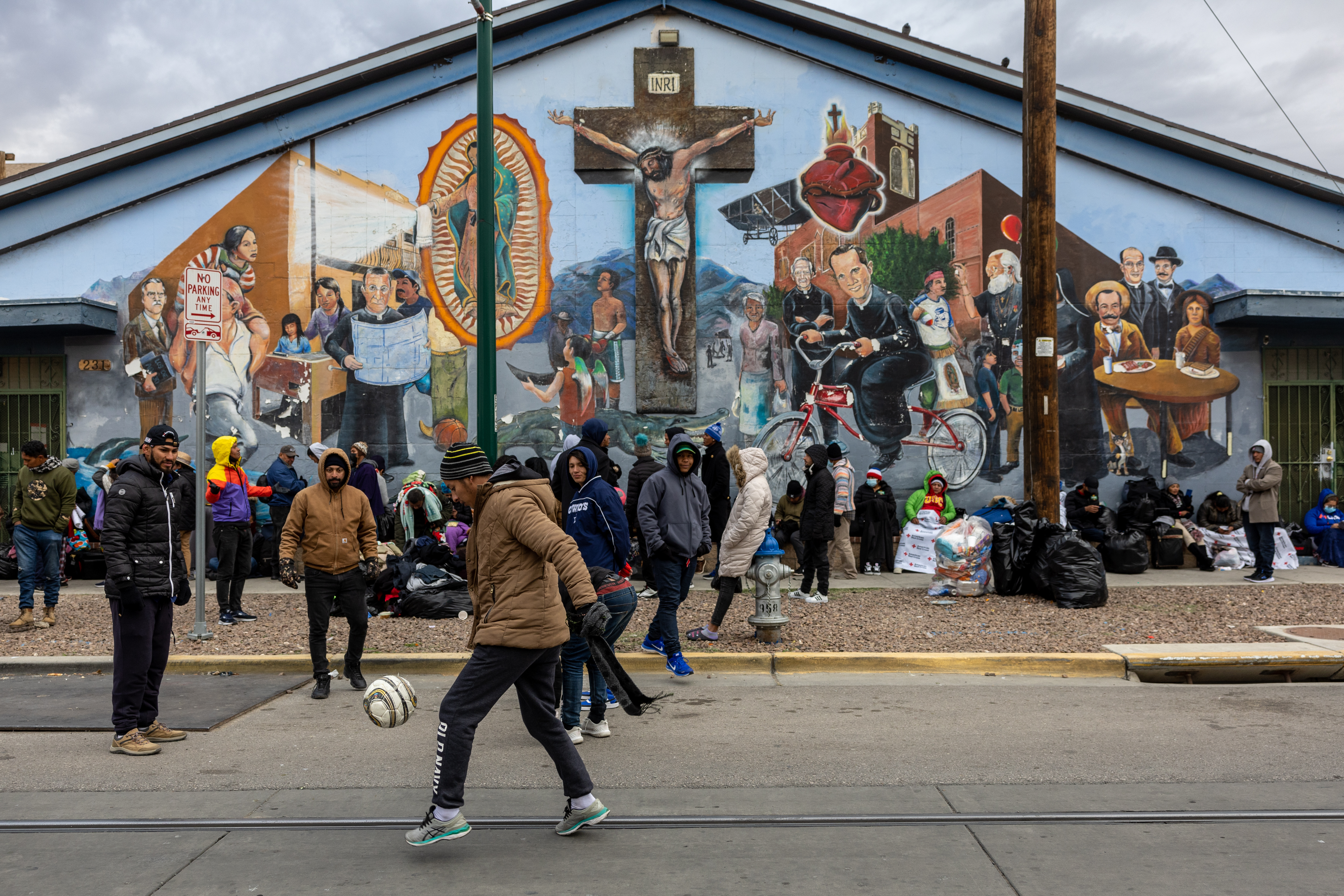 Immigrants from Ecuador gather outside a migrant shelter during the FIFA World Cup final in El Paso, Texas.&nbsp;
