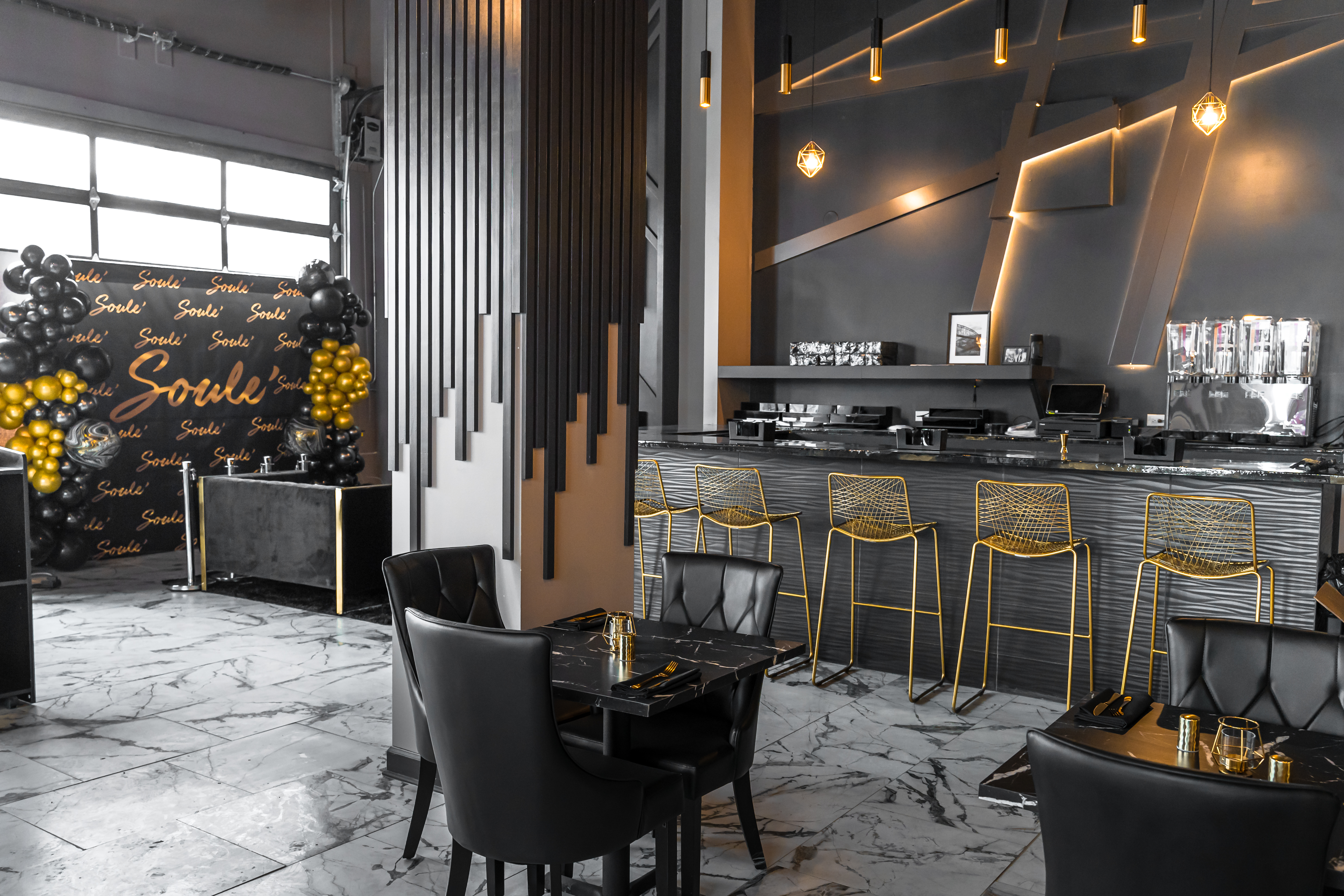 A bar and restaurant with lots of black and golds.
