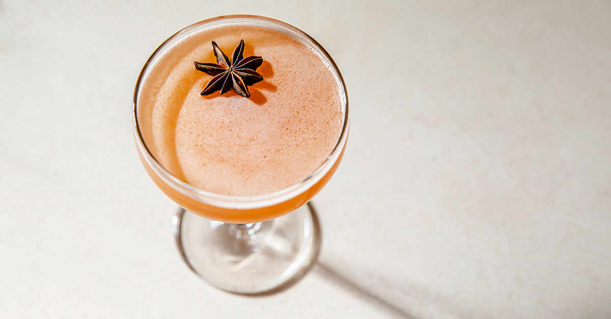 A cocktail garnished with star anise