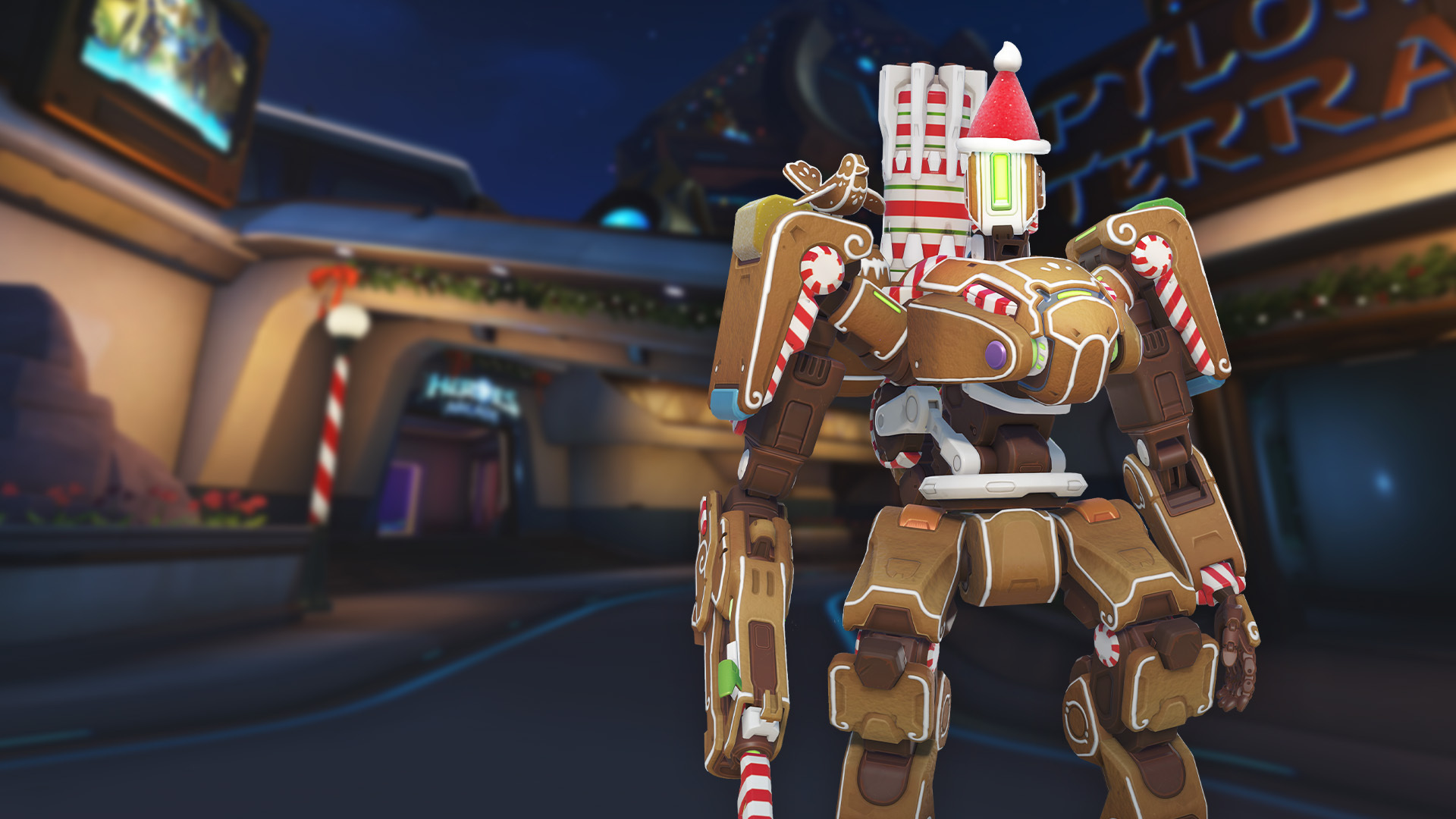 A screenshot of Gingerbread Bastion, a skin composed of cookies, icing, and peppermints, standing on the holiday-themed version of Blizzardworld in Overwatch 2