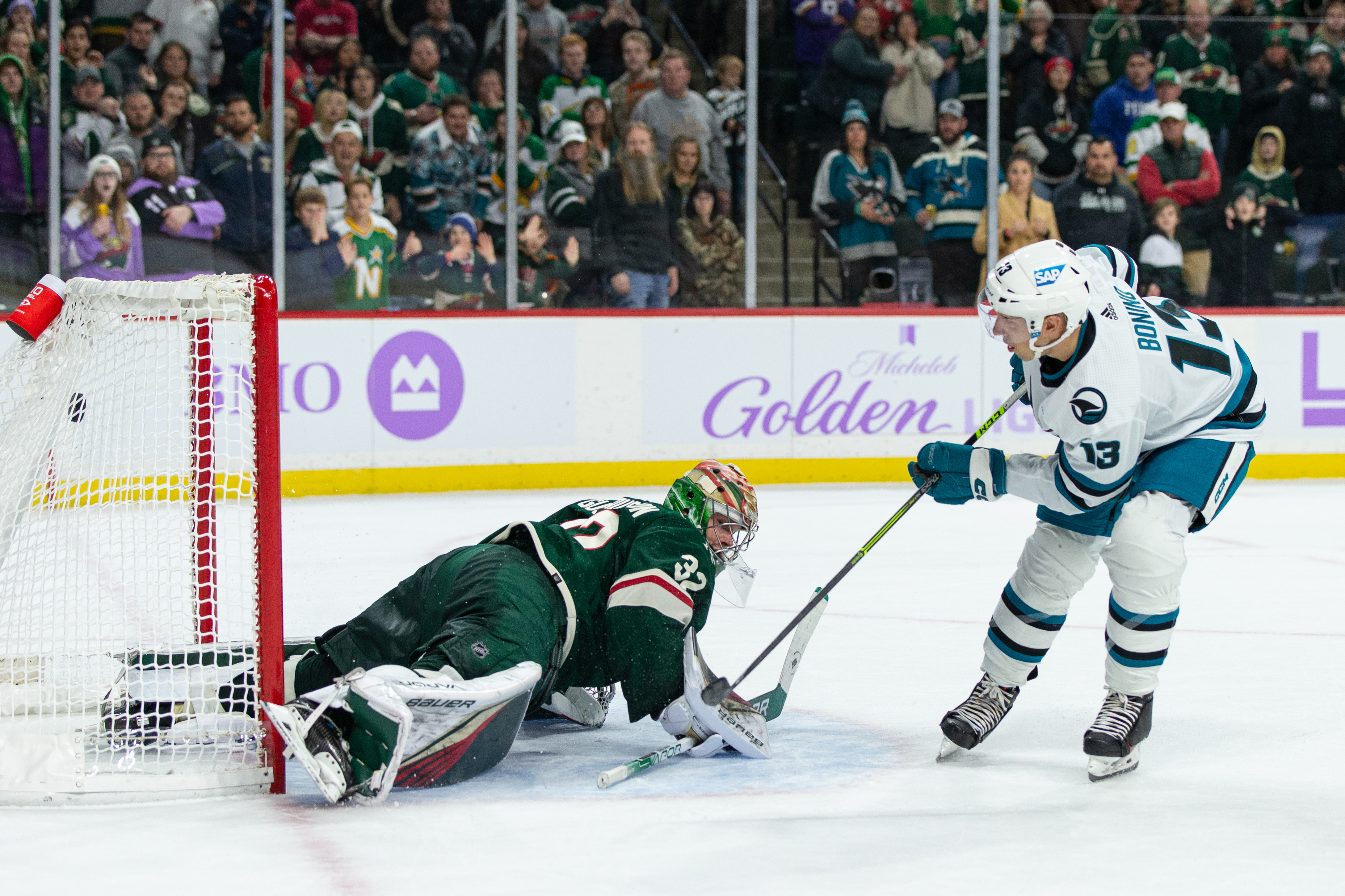 San Jose Sharks center Nick Bonino (13) scores a goal in the shootout on Minnesota Wild goaltender Filip Gustavsson (32) during the NHL game between the San Jose Sharks and the Minnesota Wild, on November 13th, 2022, at Xcel Energy Center in Saint Paul, MN.