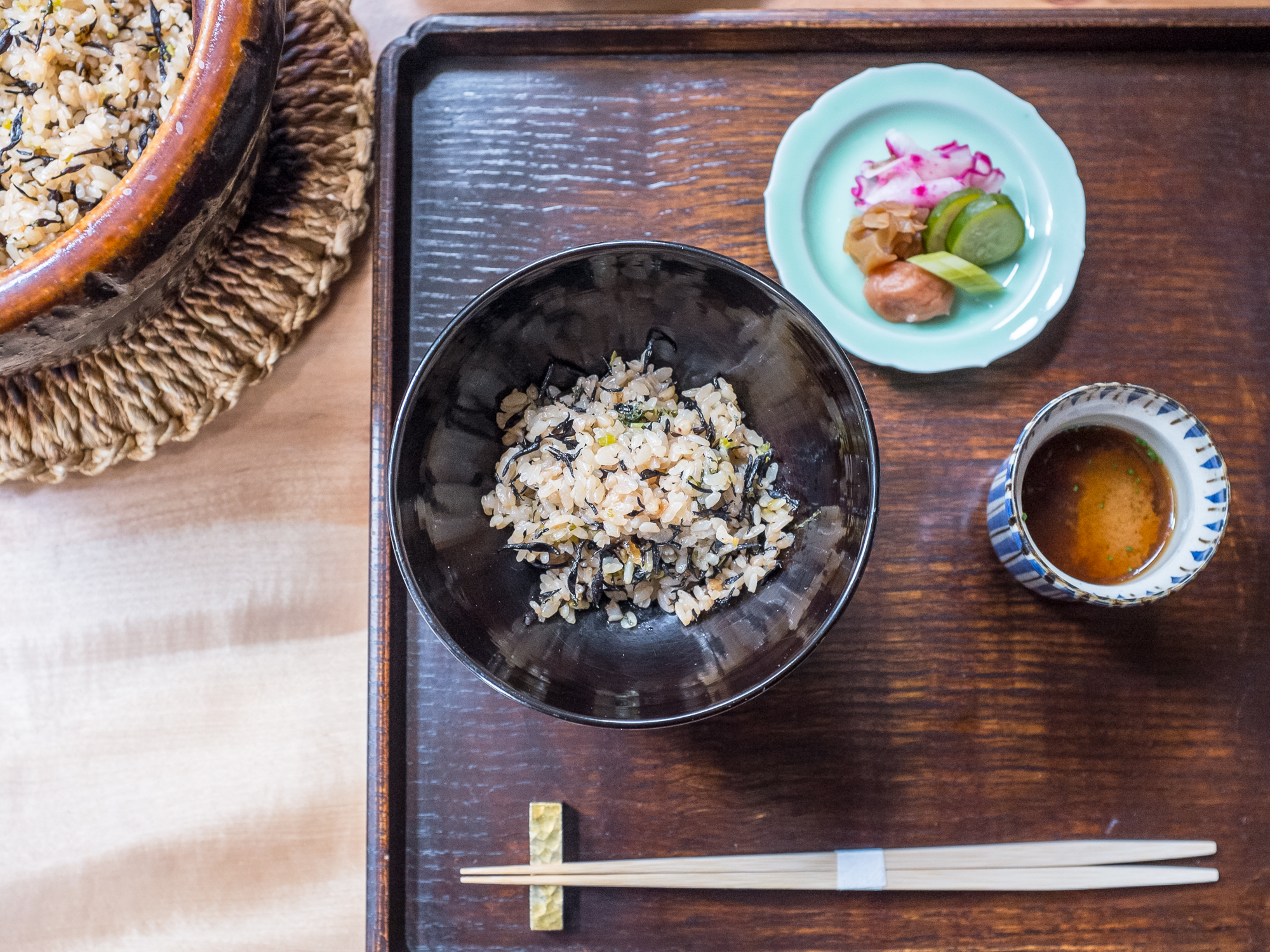 Rice and pickles on a tray with chopsticks at Kajitsu
