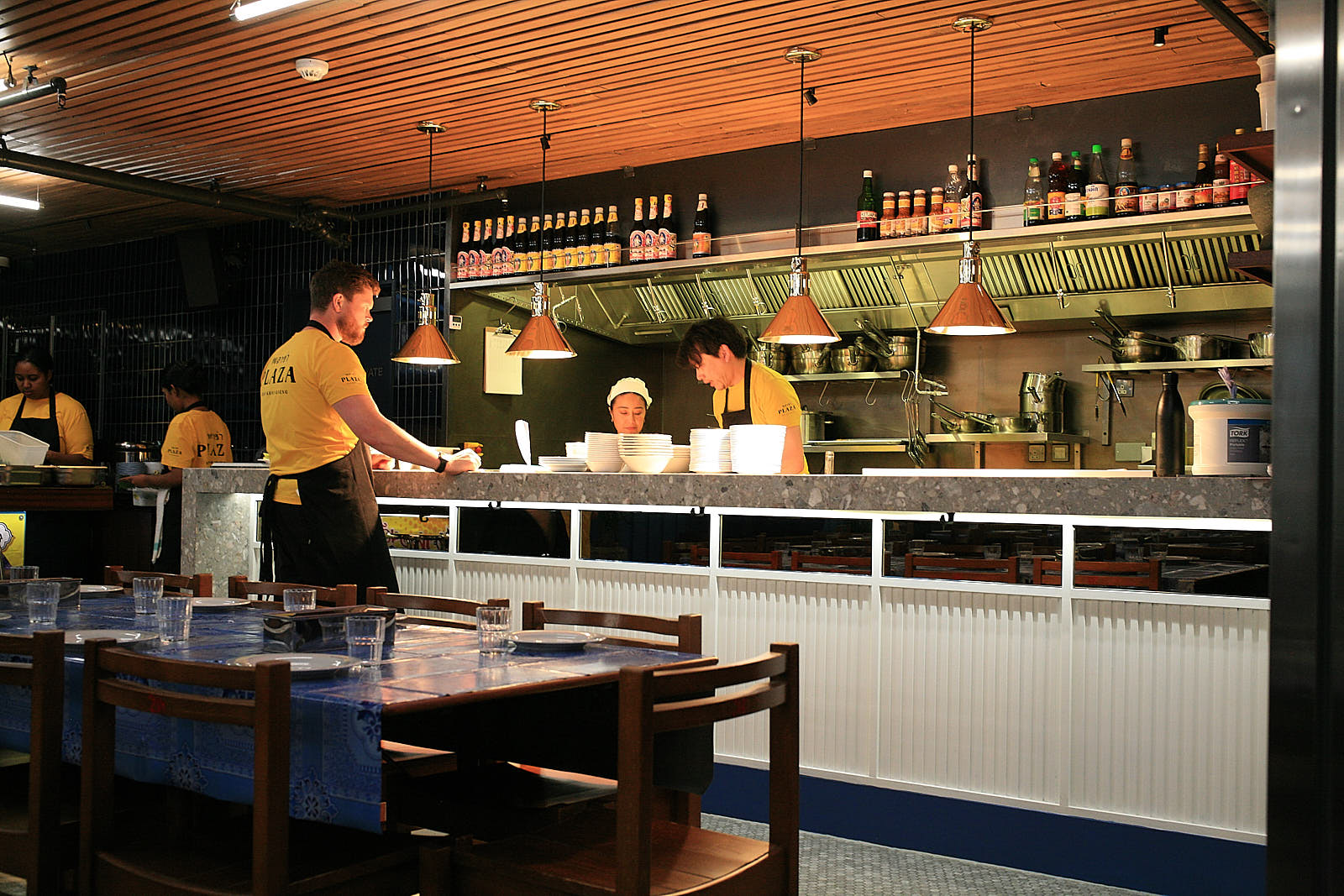 The open kitchen at Plaza, illuminated by strip lighting designed to mimic its inspiring counterparts in Thailand.