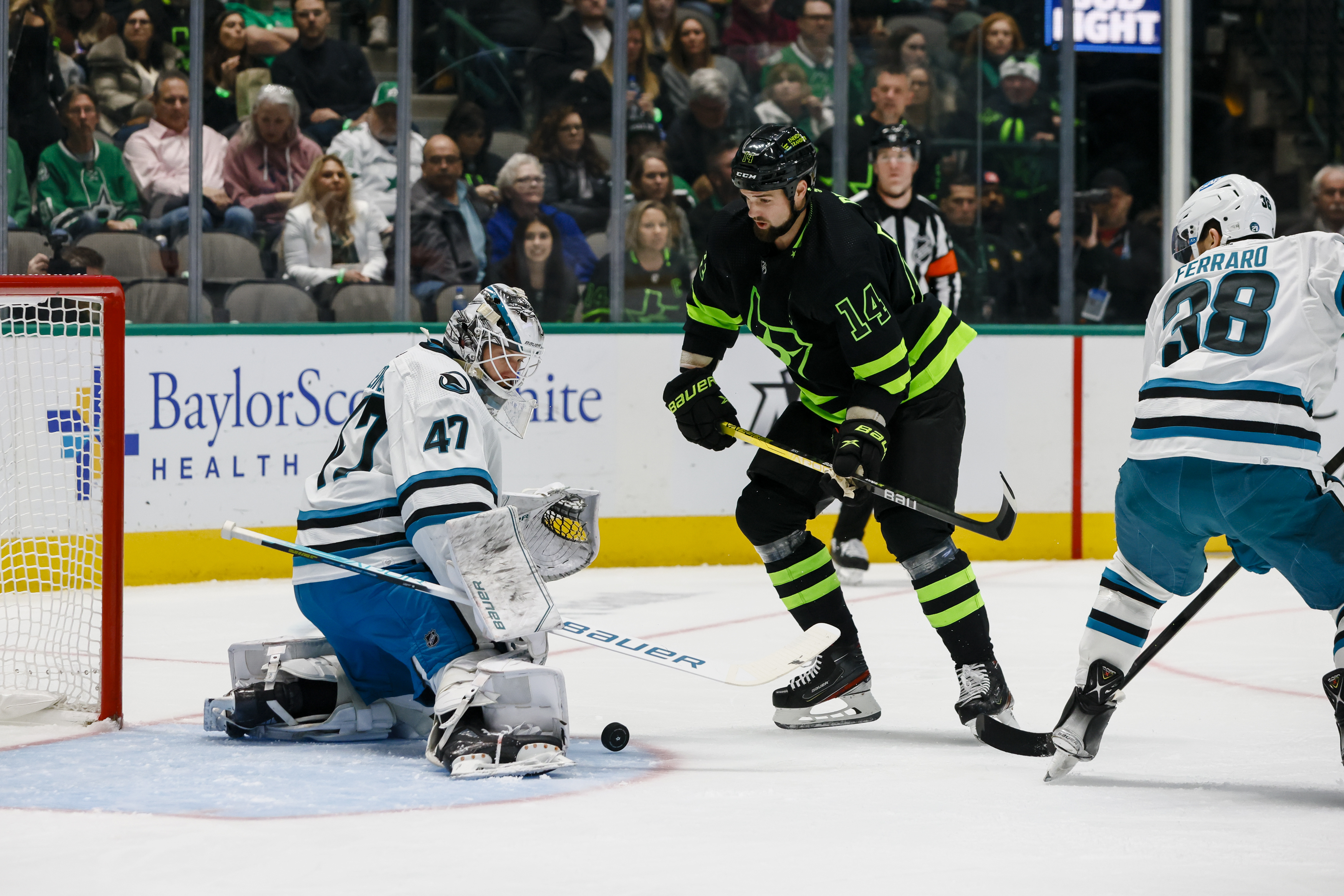 San Jose Sharks goaltender James Reimer (47) blocks a shot from Dallas Stars left wing Jamie Benn (14) during the game between the Dallas Stars and the San Jose Sharks on December 31, 2022 at American Airlines Center in Dallas, Texas.