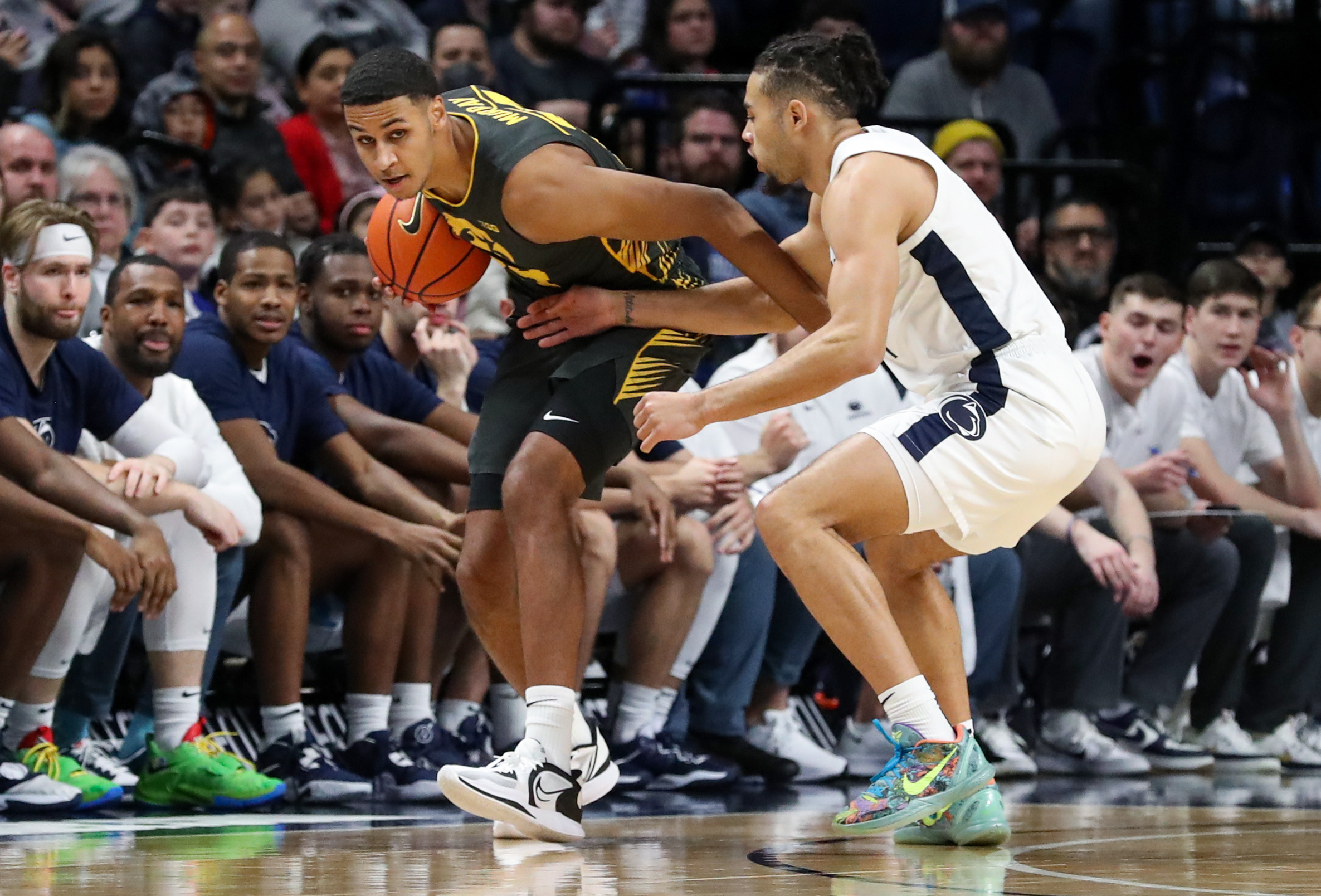 Jan 1, 2023; University Park, Pennsylvania, USA; Iowa Hawkeyes forward Kris Murray (24) holds onto the ball as Penn State Nittany Lions guard/forward Seth Lundy (1) defends during the first half at Bryce Jordan Center.
