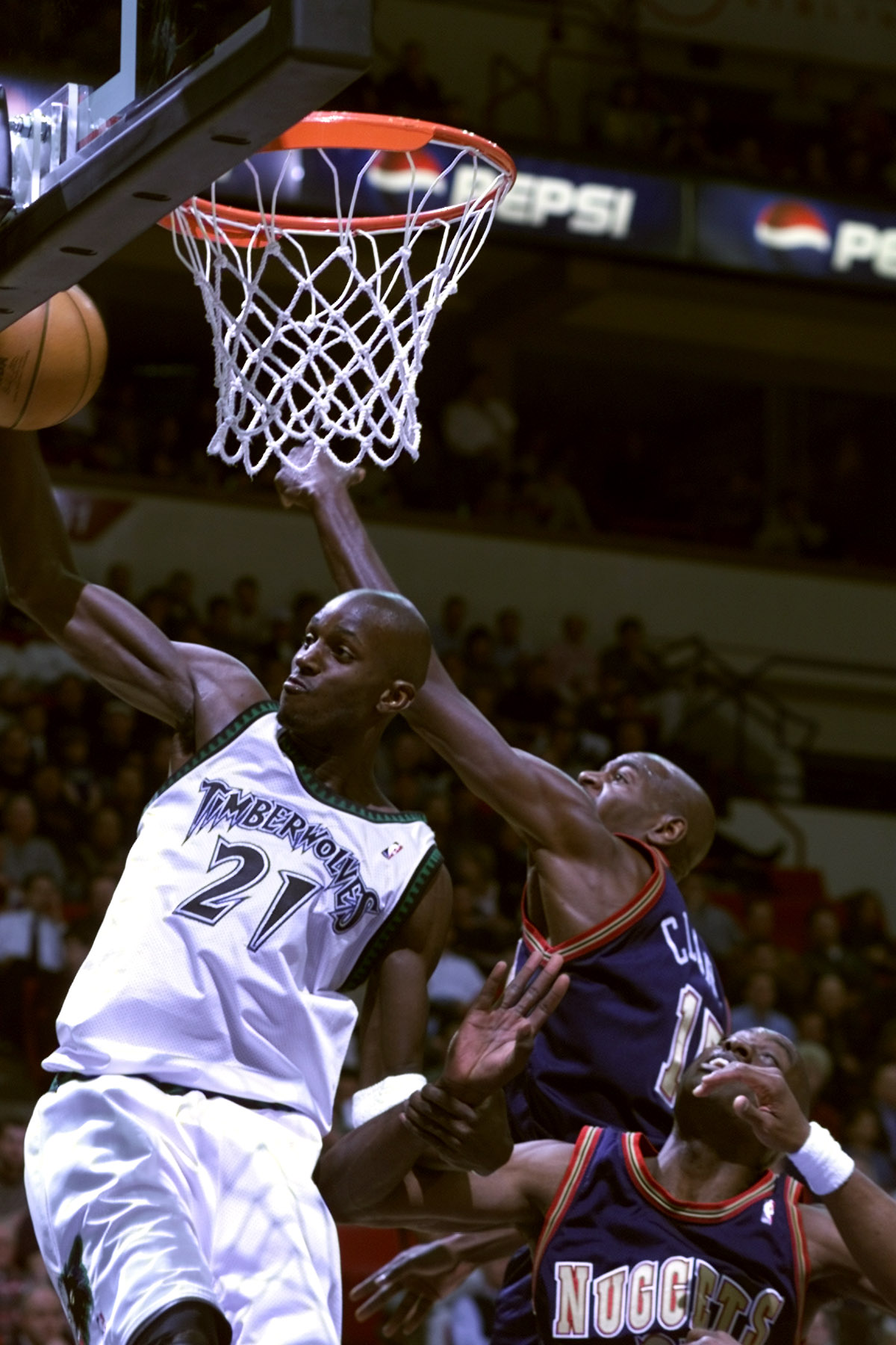 Minneapolis Mn, Timberwolves vs Denver Nuggets. — Timberwolves Kevin Garnett pulls down a defensive reboound over Denver’s Keon Clark during 2nd period NBA action at the Target Center.