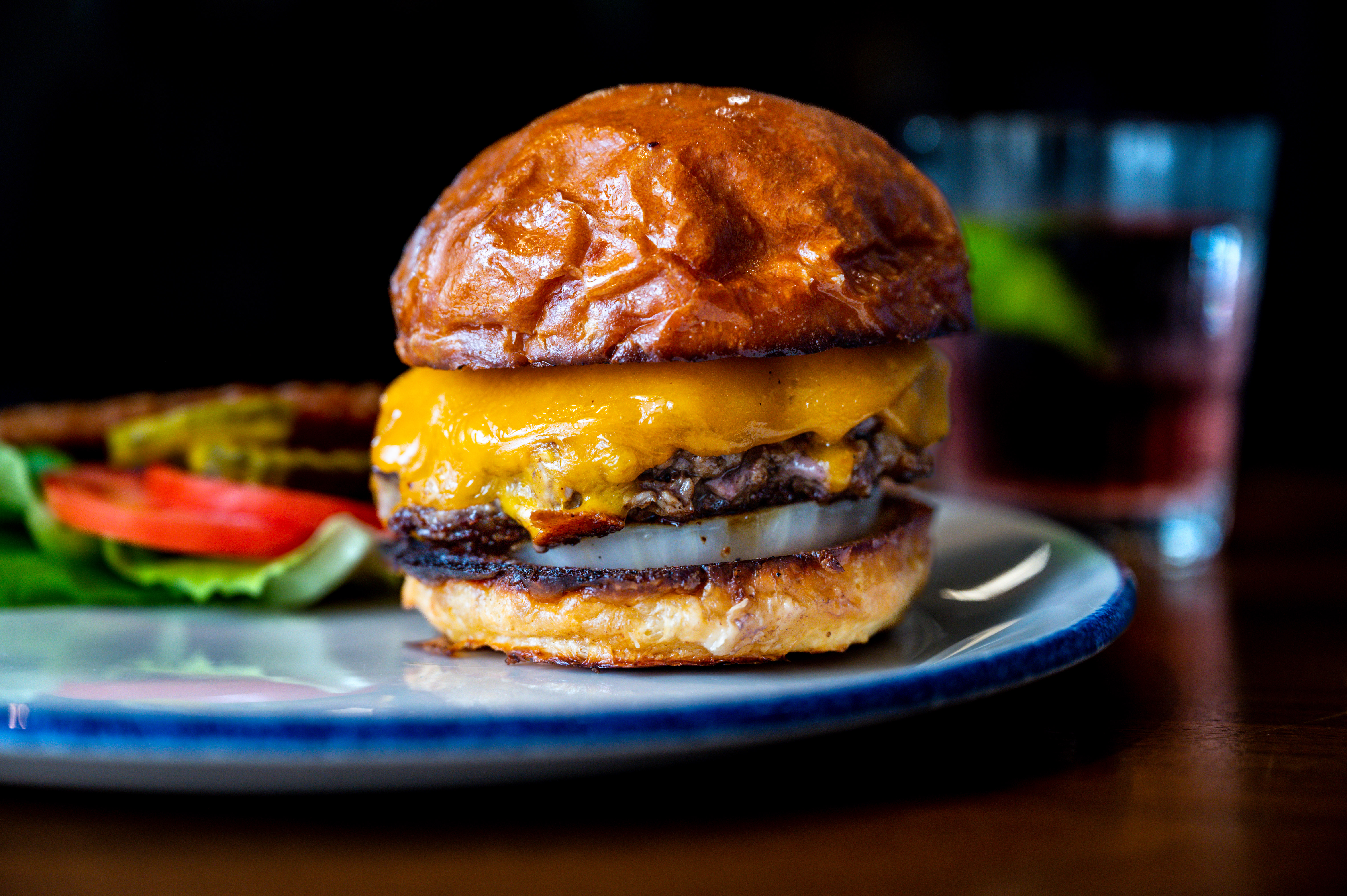 A cheeseburger on a blue plate