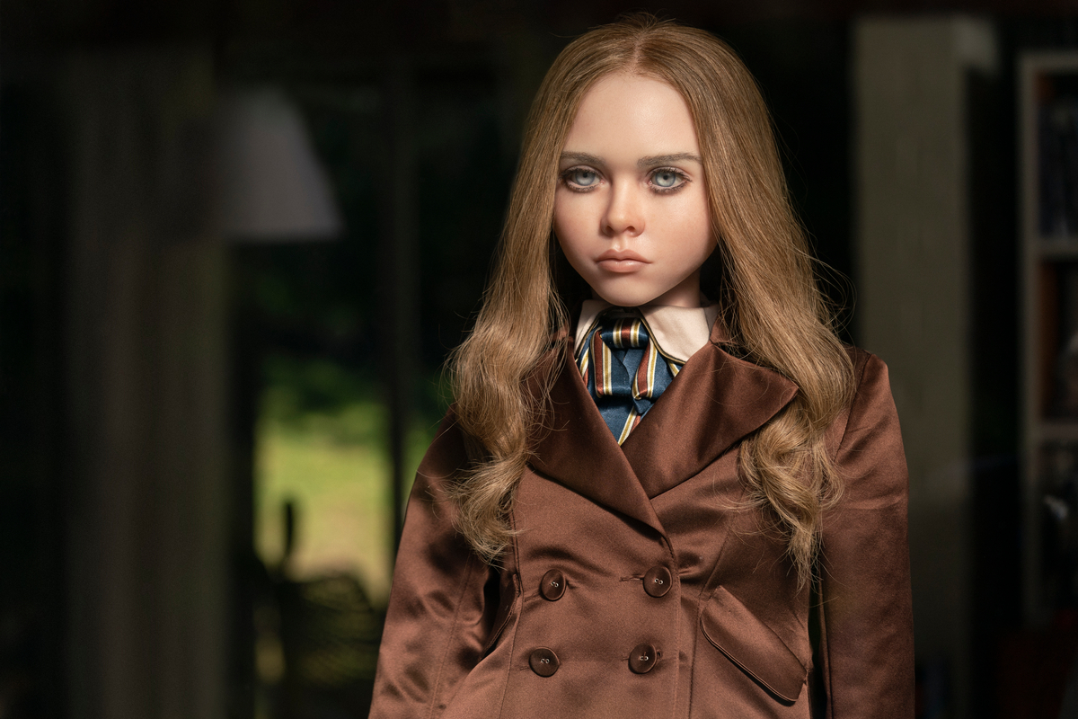 M3GAN, the lifelike robot-doll from M3GAN, faces the camera with an expressionless yet somewhat threatening look on her face.
