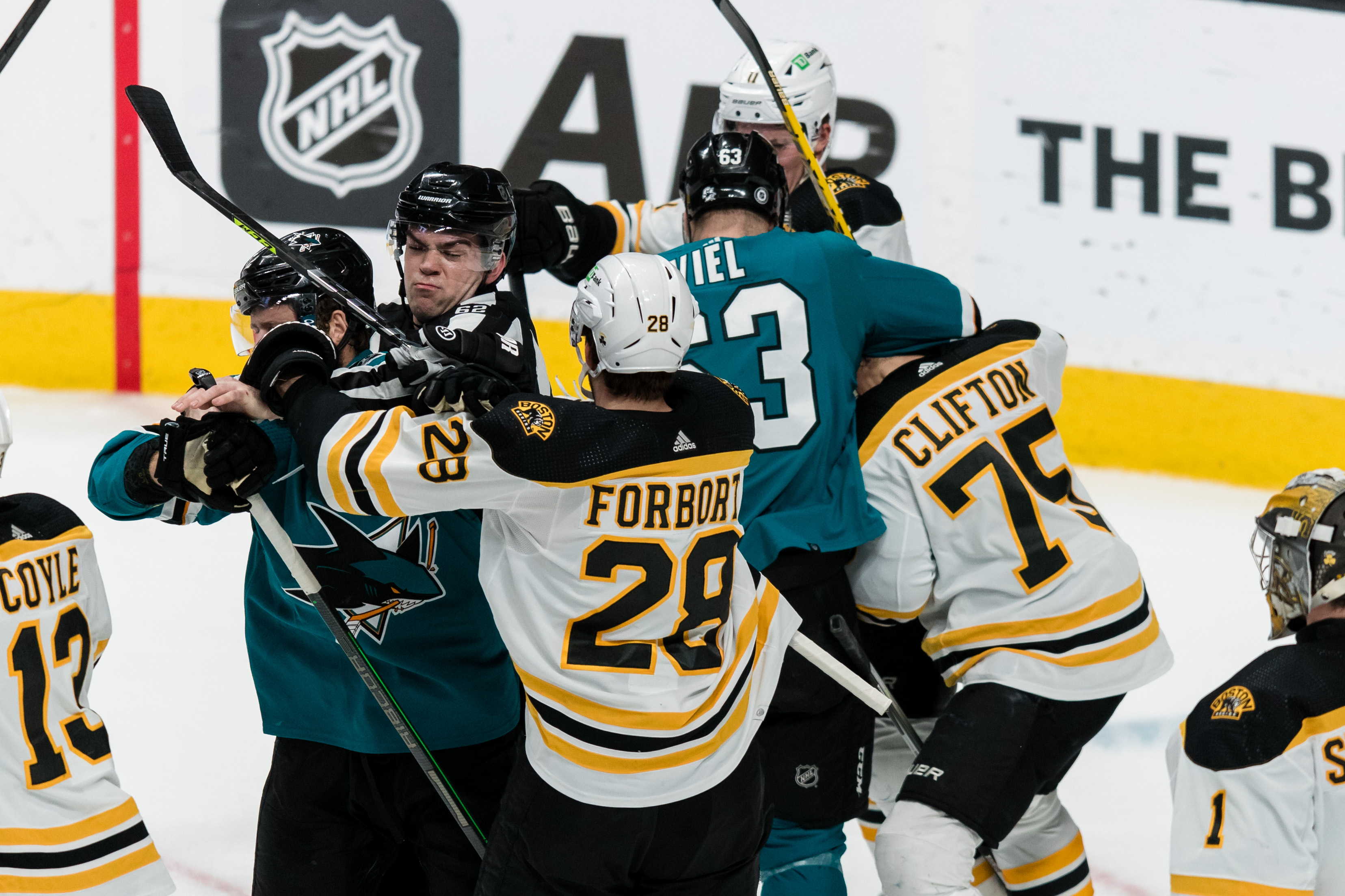 Feb 26, 2022; San Jose, California, USA; Boston Bruins defenseman Connor Clifton (75) and and defenseman Derek Forbort (28) and San Jose Sharks left wing Jeffrey Viel (63) and other players fight during the third period at SAP Center at San Jose.