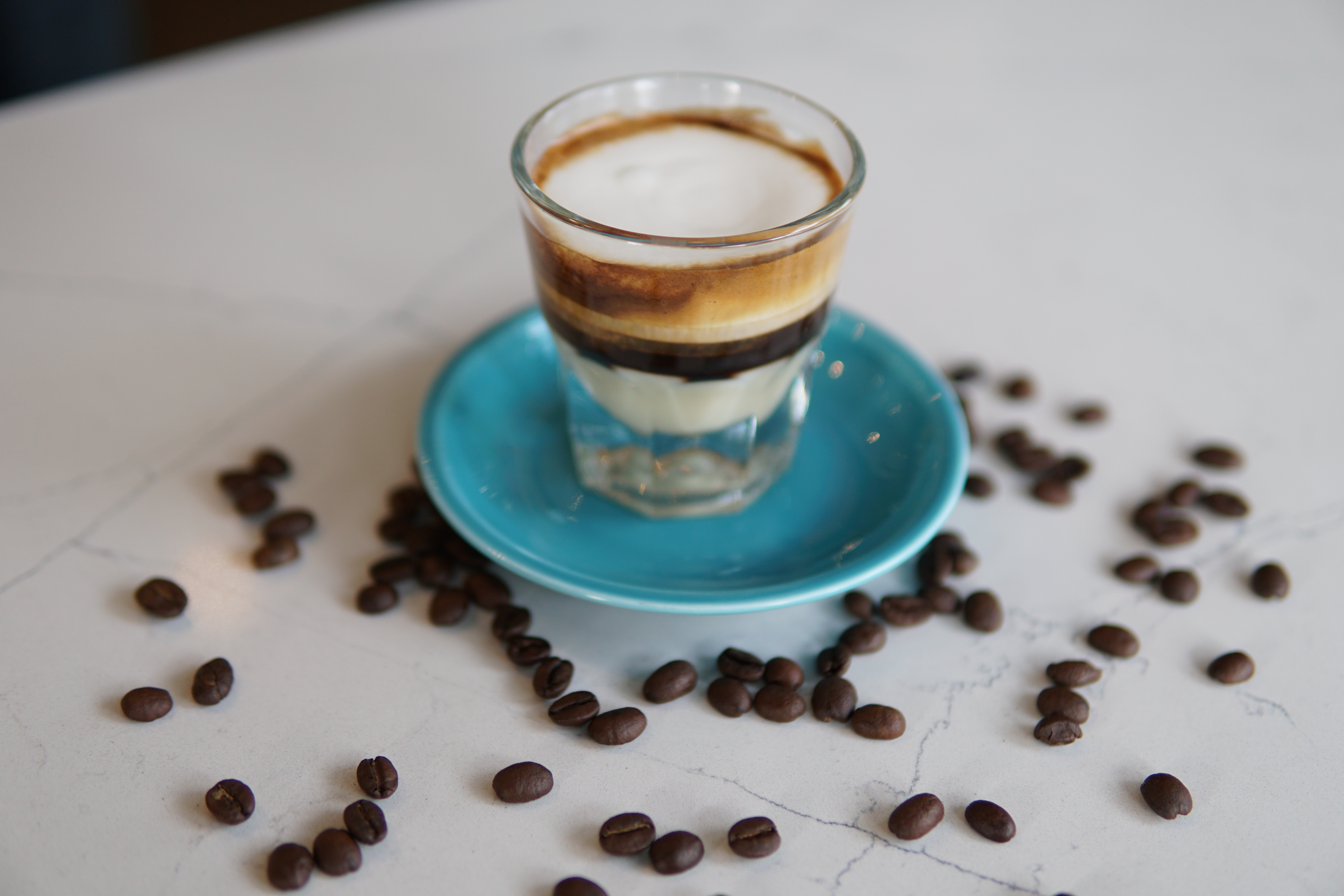 Cuban coffee is served in a small glass cup.