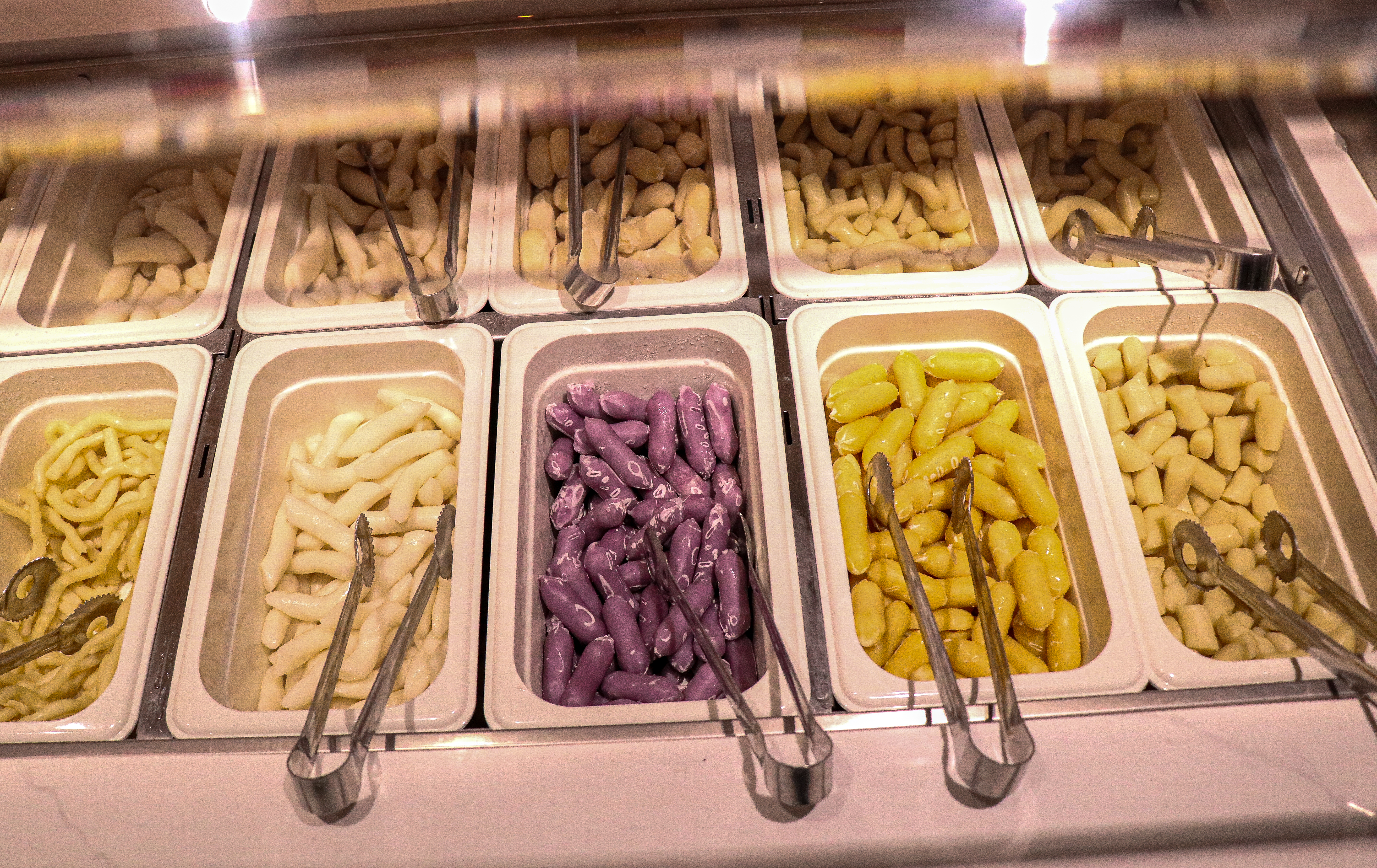 A variety of tteokbokki in buffet containers