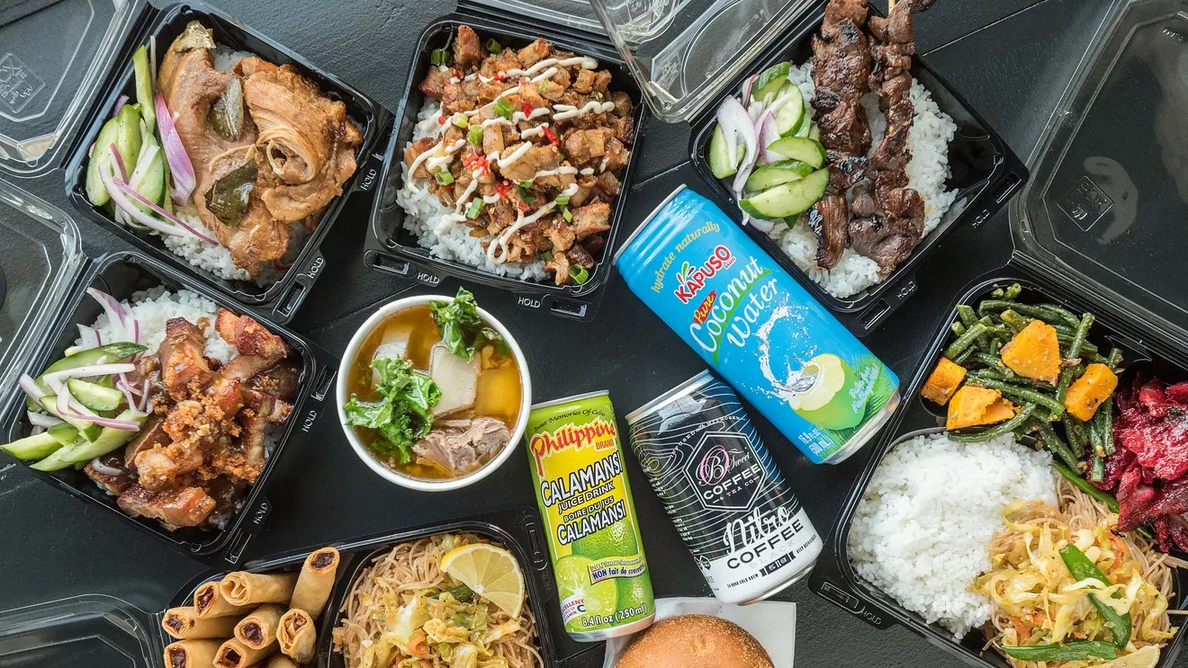 An overhead shot of Big Boi food, Filipino classics with roast meat and rice and drinks.