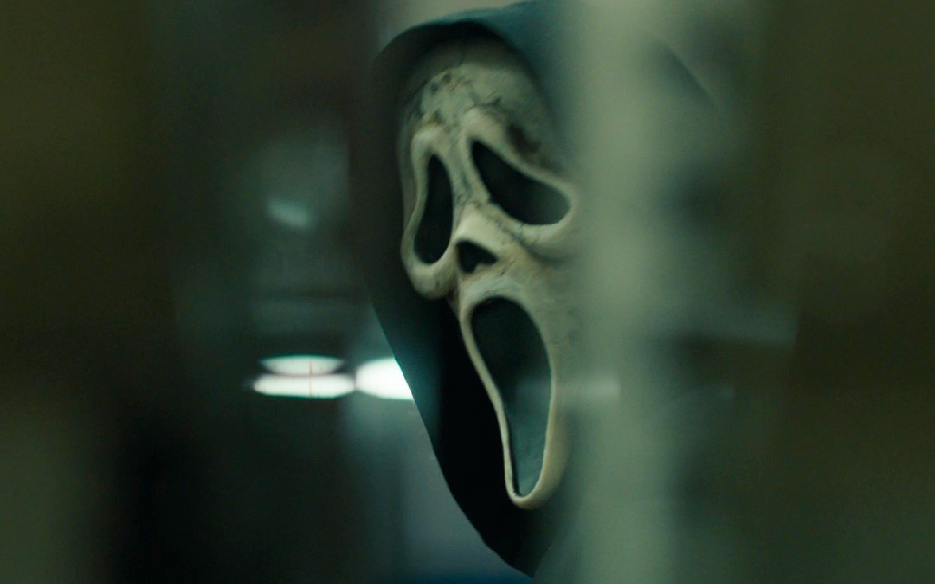 A blurry close-up image of Ghostface’s mask from Scream 6