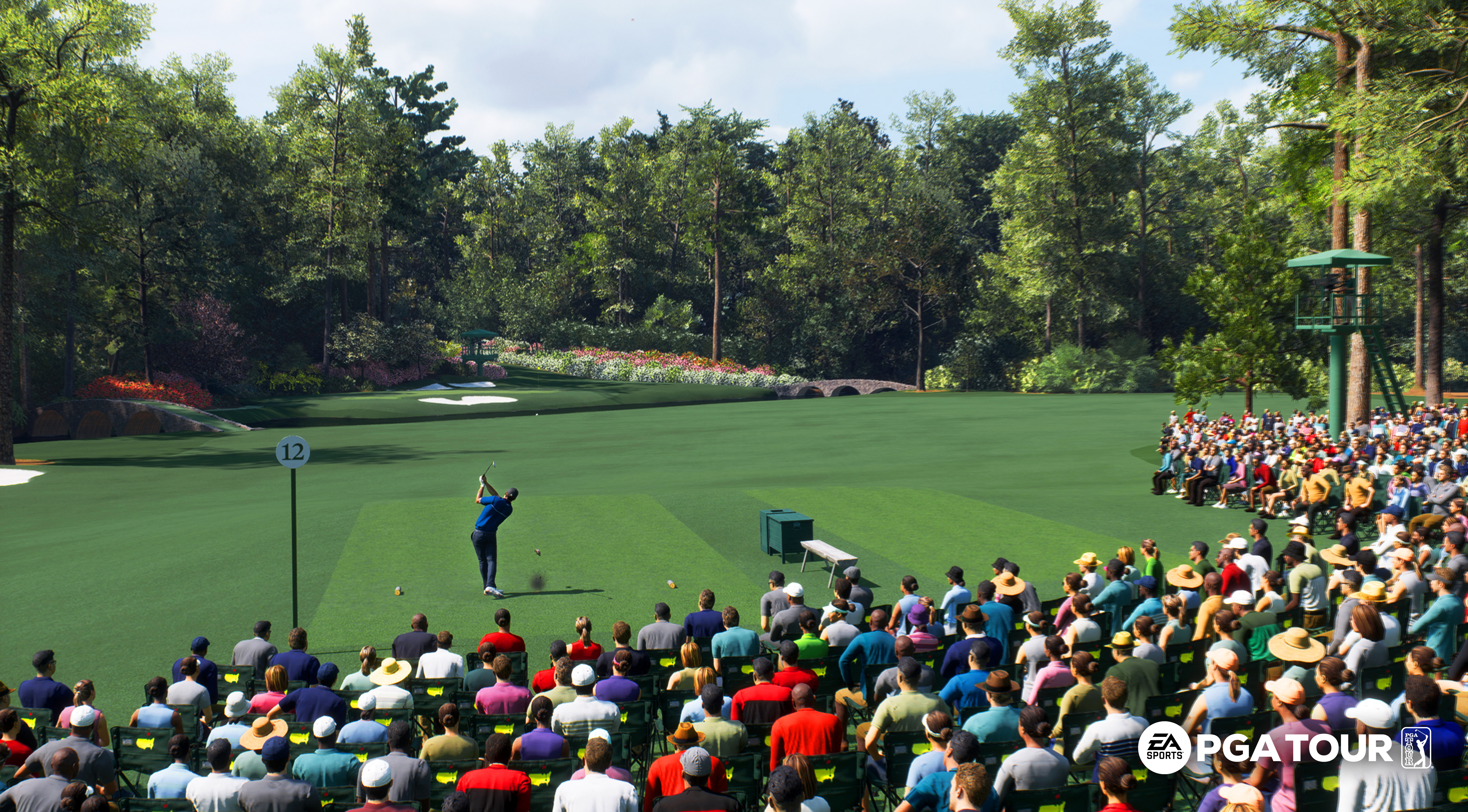 a screenshot from EA Sports PGA Tour of hole 12 at Augusta National, seen from the crowd: a golfer launches his drive at a par-3 green in the distance