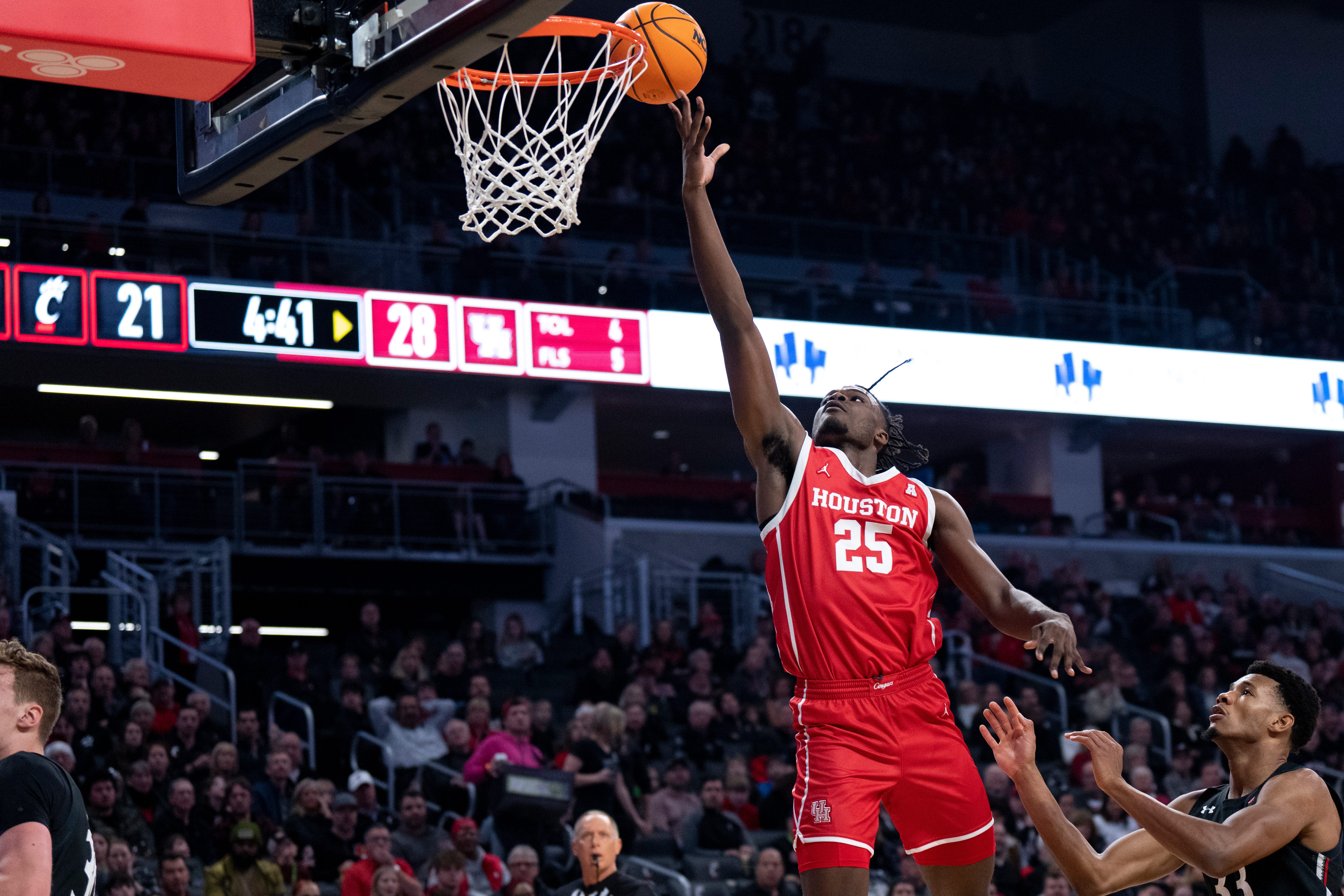 Houston Cougars forward Jarace Walker lays the ball up as Cincinnati Bearcats forward Ody Oguama looks on in the first half of the NCAA men s basketball game between the Cincinnati Bearcats and the Houston Cougars at Fifth Third Arena in Cincinnati on Sunday, Jan. 8, 2023.
