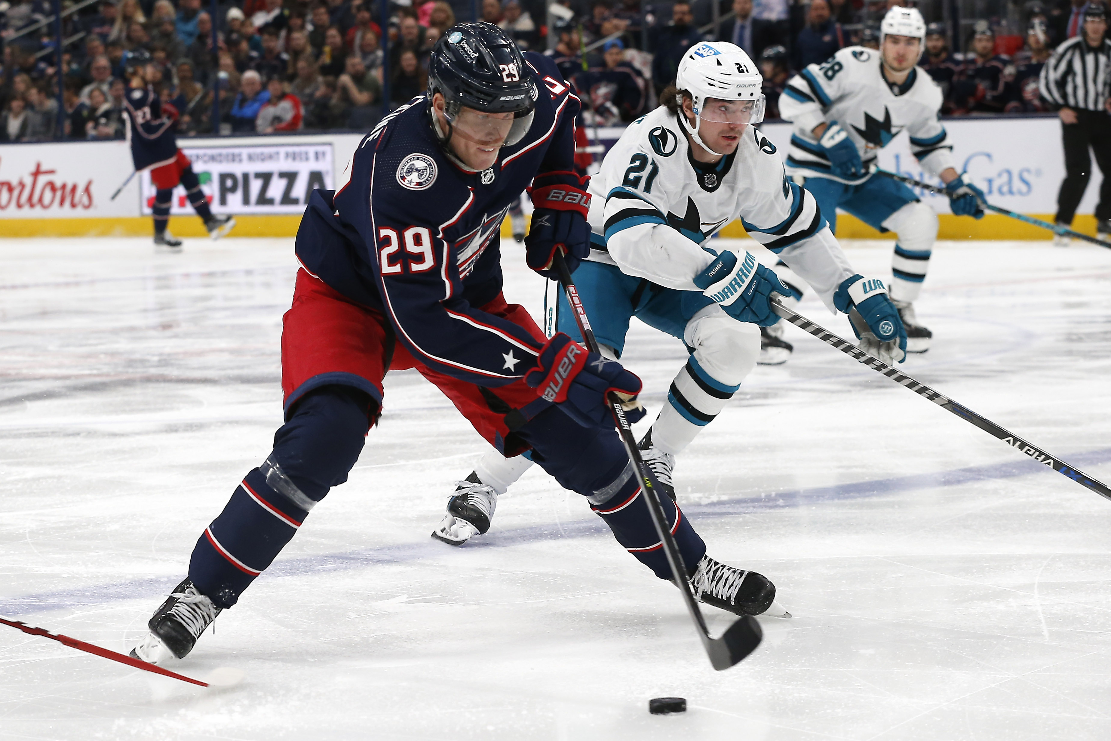 Jan 21, 2023; Columbus, Ohio, USA; Columbus Blue Jackets right wing Patrik Laine (29) carries the puck as San Jose Sharks center Mikey Eyssimont (21) trails the play during the first period at Nationwide Arena.