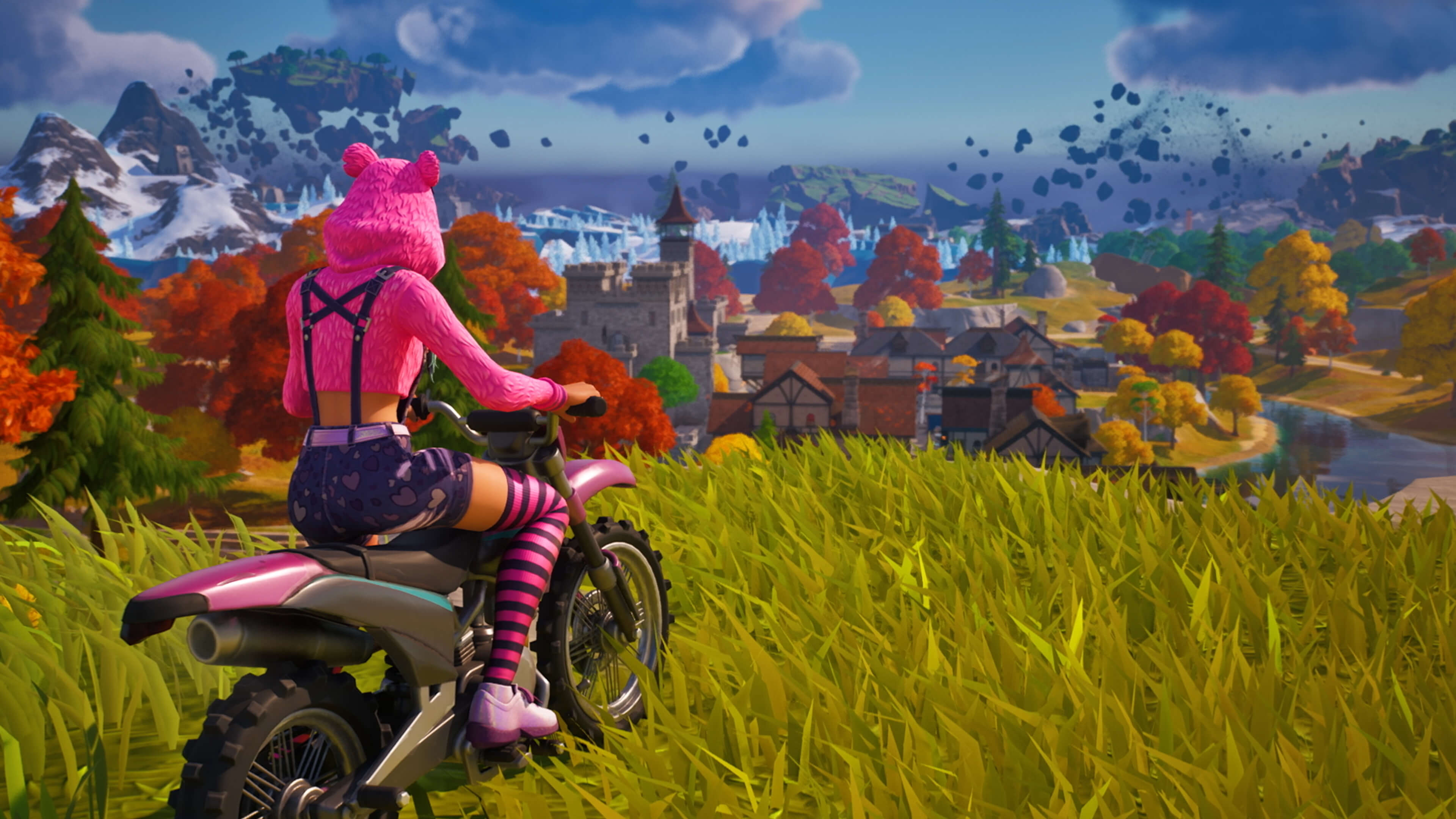 A Fortnite character in a pink fuzzy bear hoodie overlooks a town while atop a motorcycle