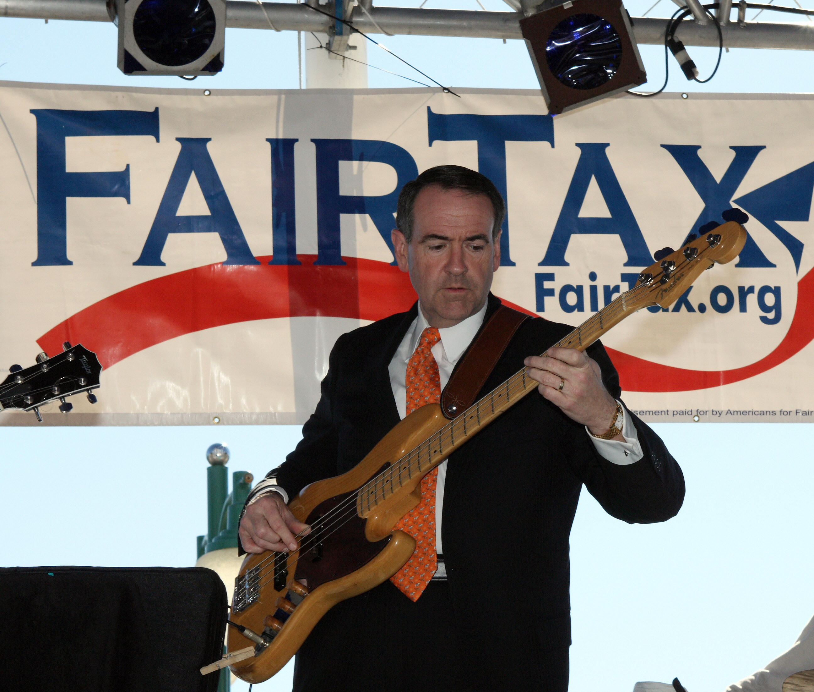 Mike Huckabee on stage playing an electric bass at a FairTax rally in Jacksonville, Florida, on January 27, 2008.
