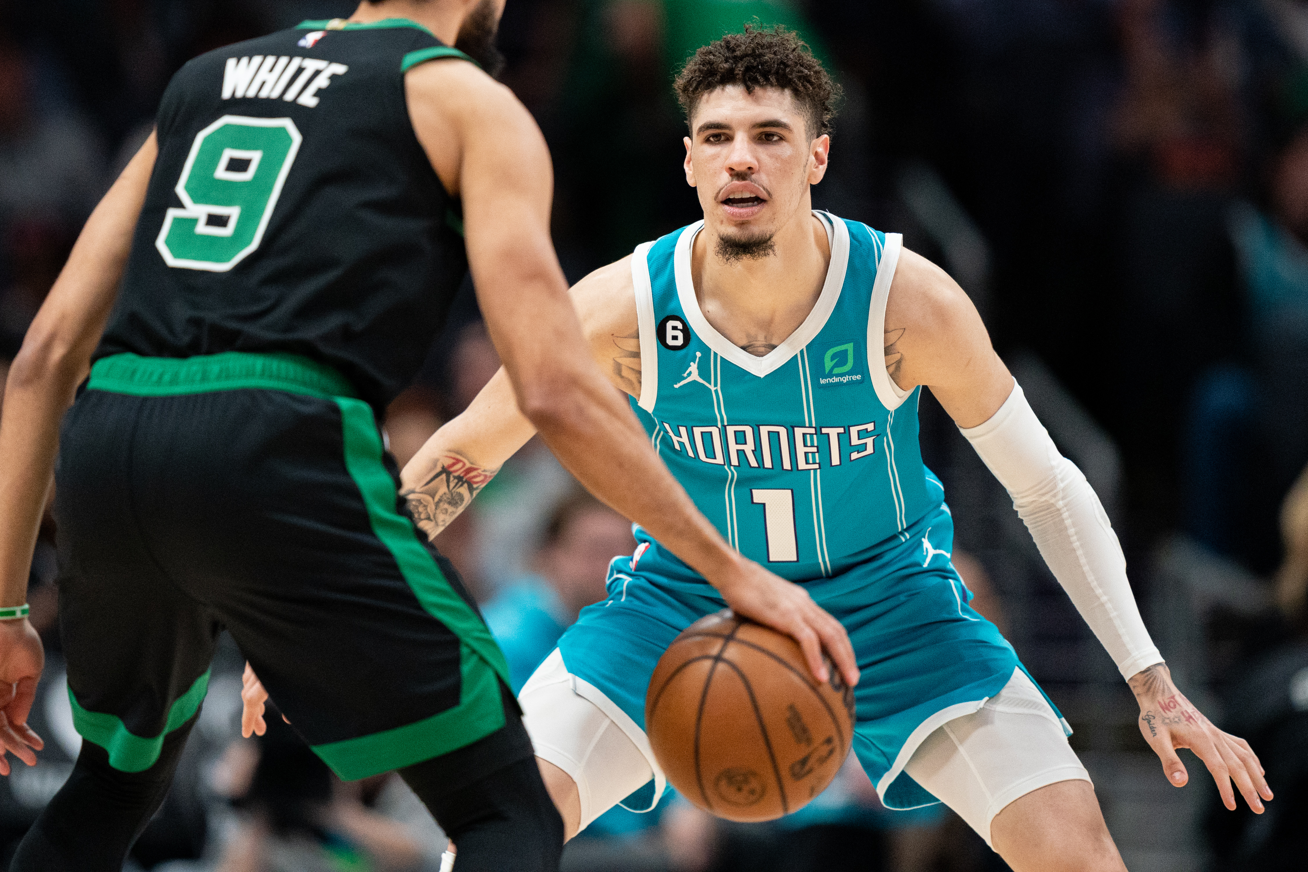 LaMelo Ball of the Charlotte Hornets guards Derrick White of the Boston Celtics during their game at Spectrum Center on January 16, 2023 in Charlotte, North Carolina.
