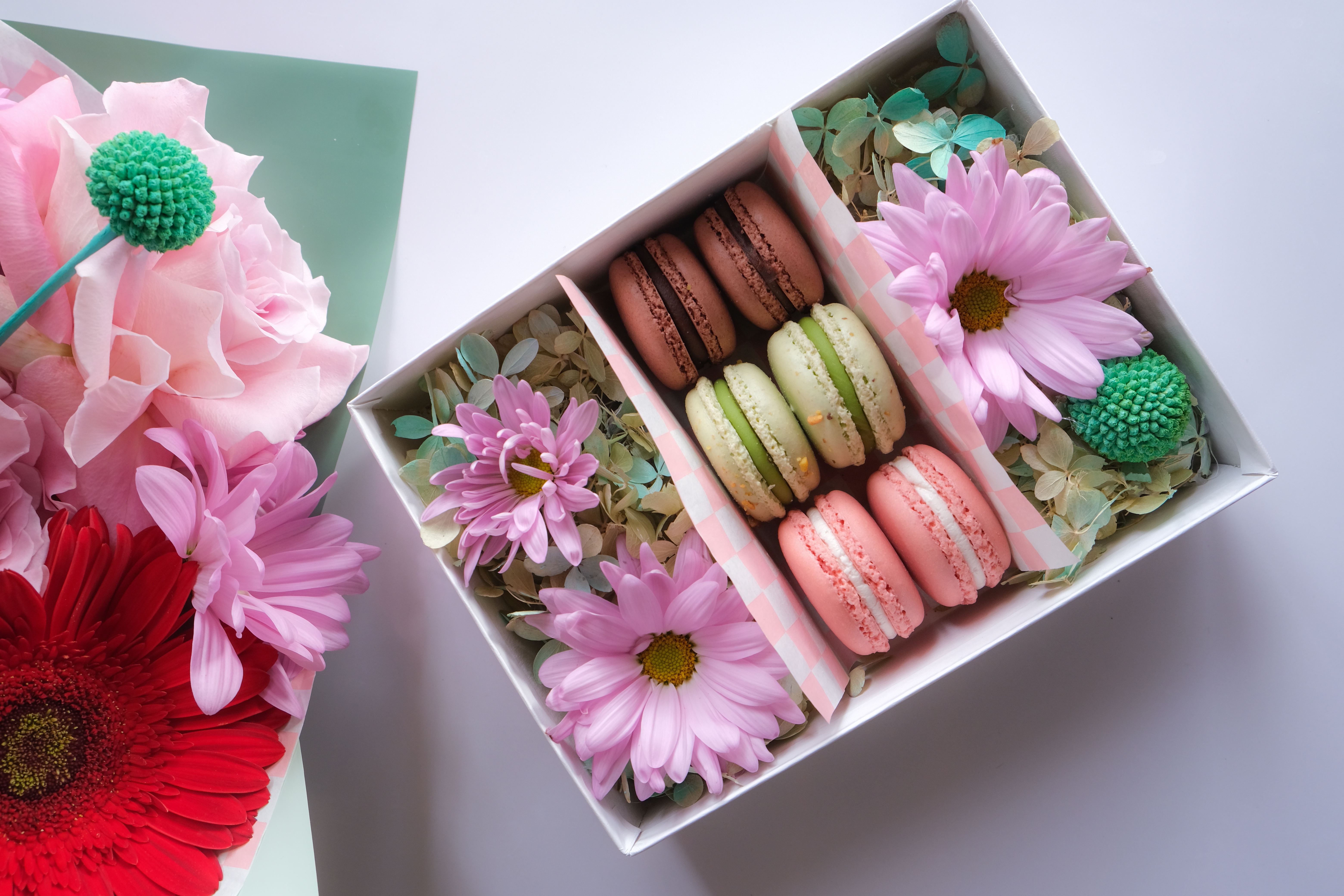 A box of flowers and macarons.