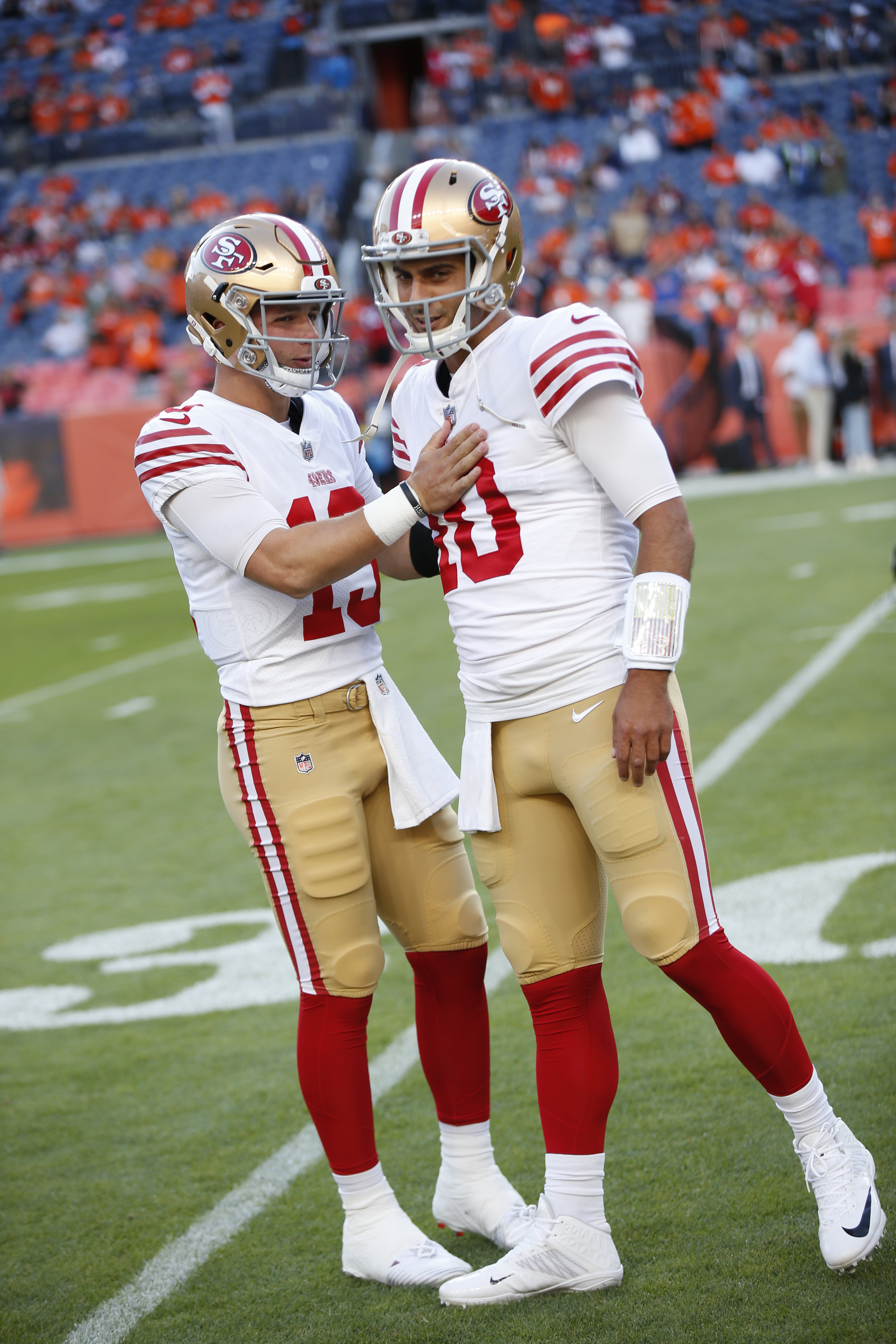 Brock Purdy #13 and Jimmy Garoppolo #10 of the San Francisco 49ers on the field before the game against the Denver Broncos at Empower Field At Mile High on September 25, 2022 in Denver, Colorado.