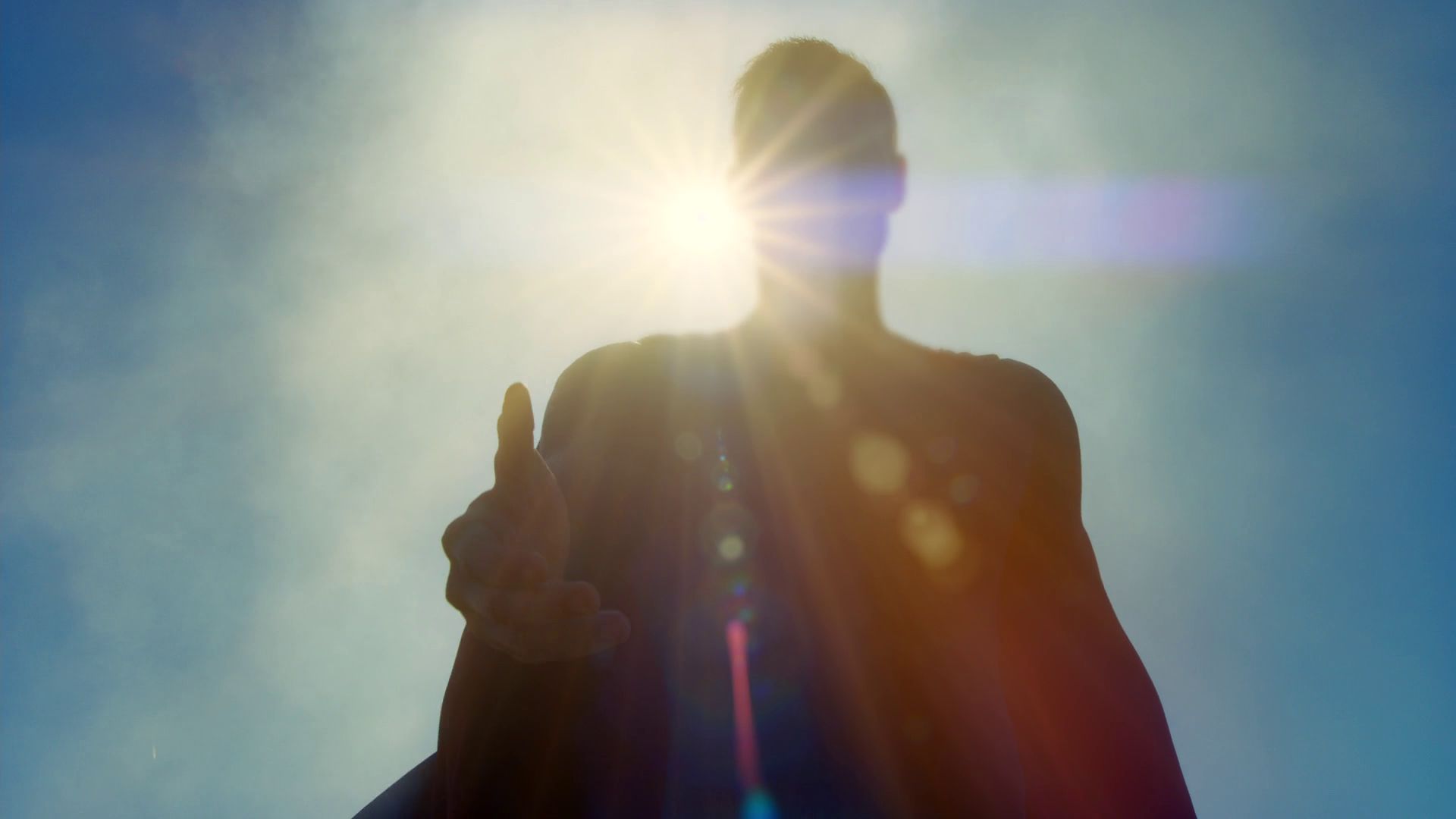 A superman backlit by the sun so you can’t see who it is