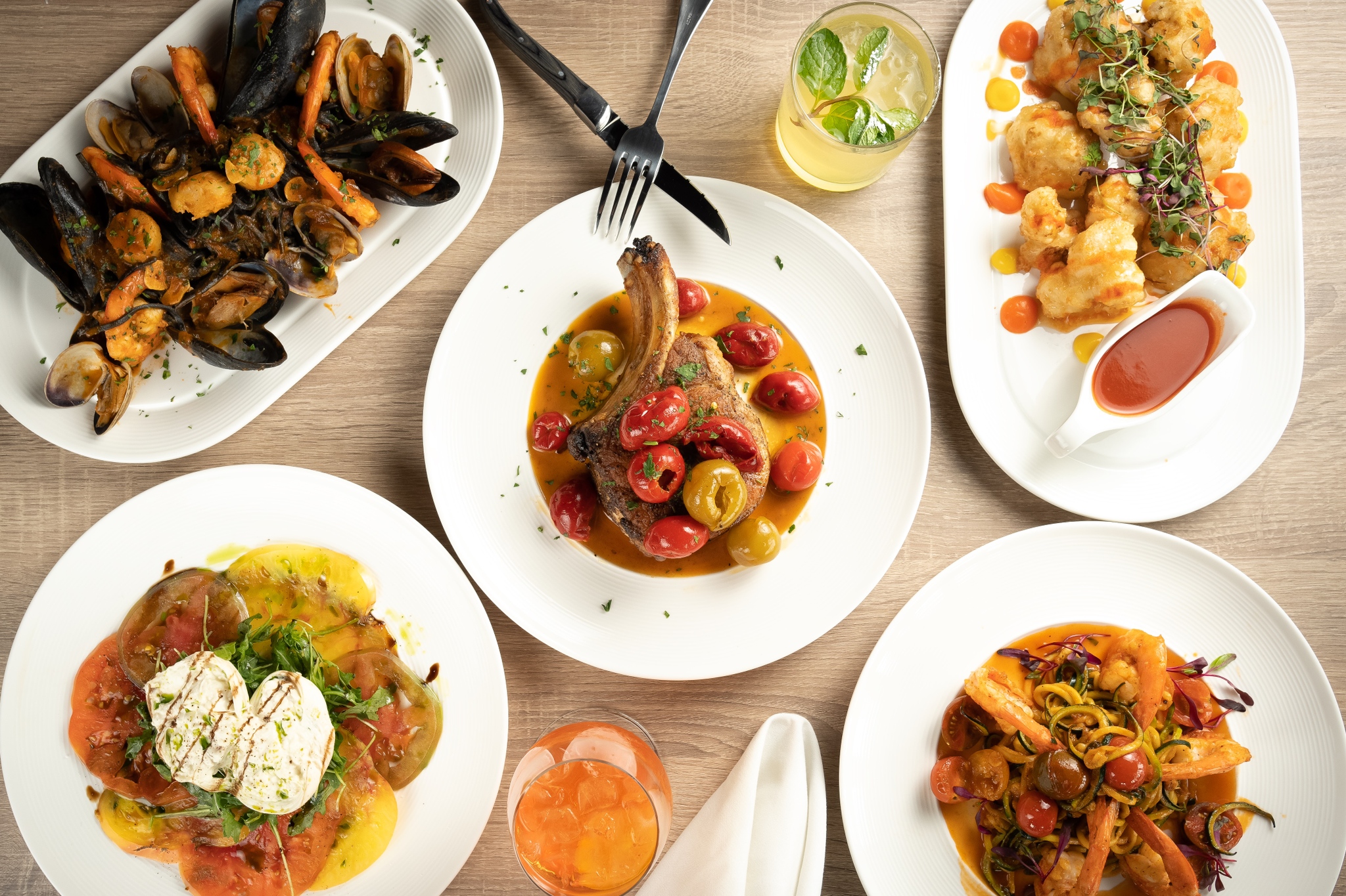 A spread of Italian dishes with pasta and seafood.