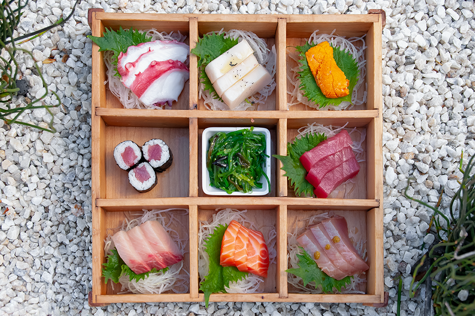 A box filled with sashimi.