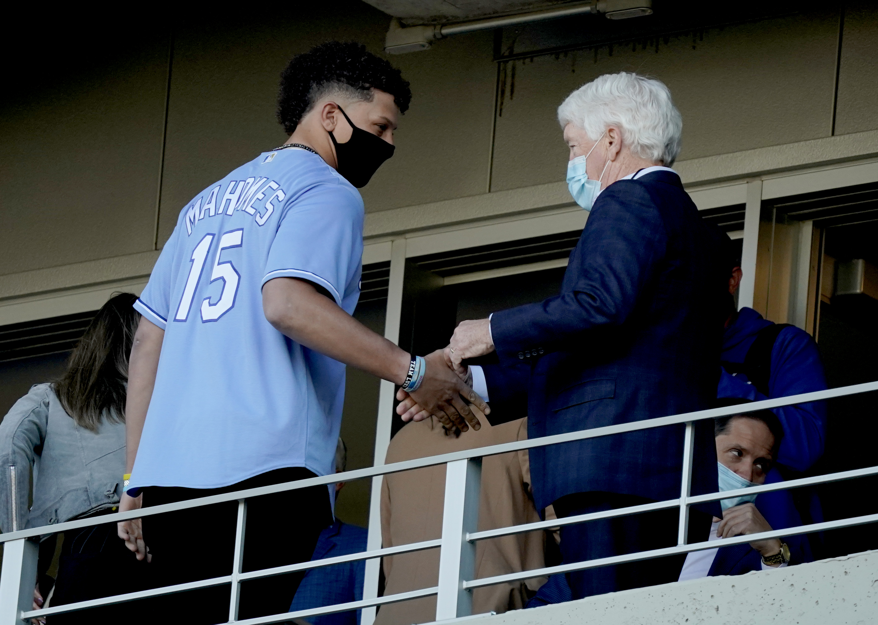 Co-owners of the Royals, Patrick Mahomes and John Sherman shake hands