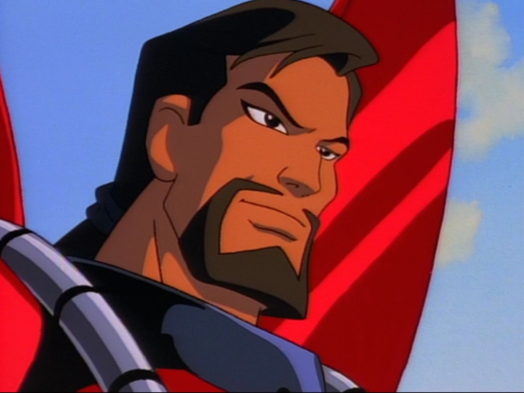 A close-up shot of an animated man with a brown goatee and ponytail in red armor stars off at something in the distance.