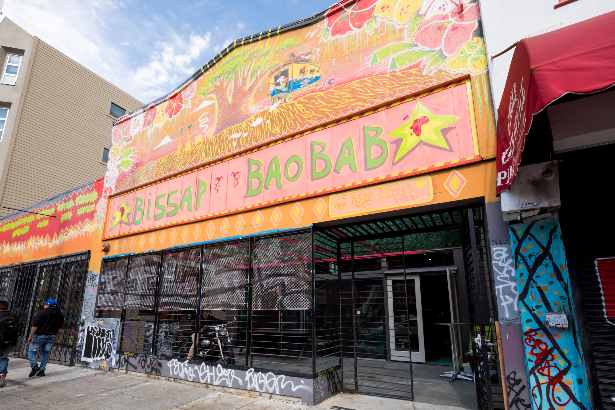 The exterior of Big Baobab painted in orange, pink, and yellow.