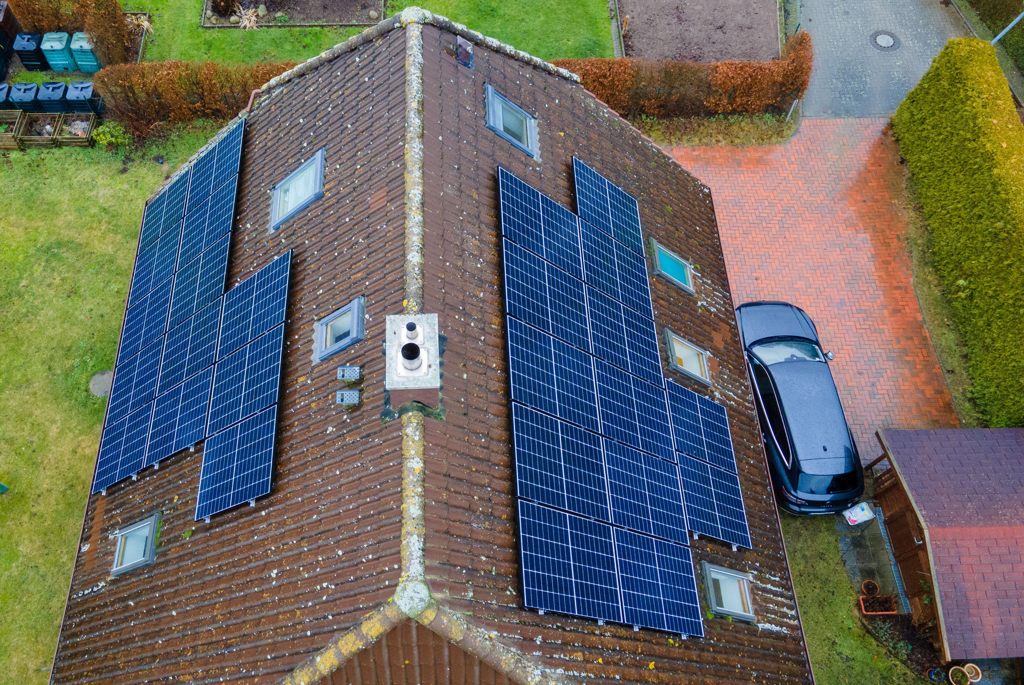 The roof of a house with solar panels, viewed from above.