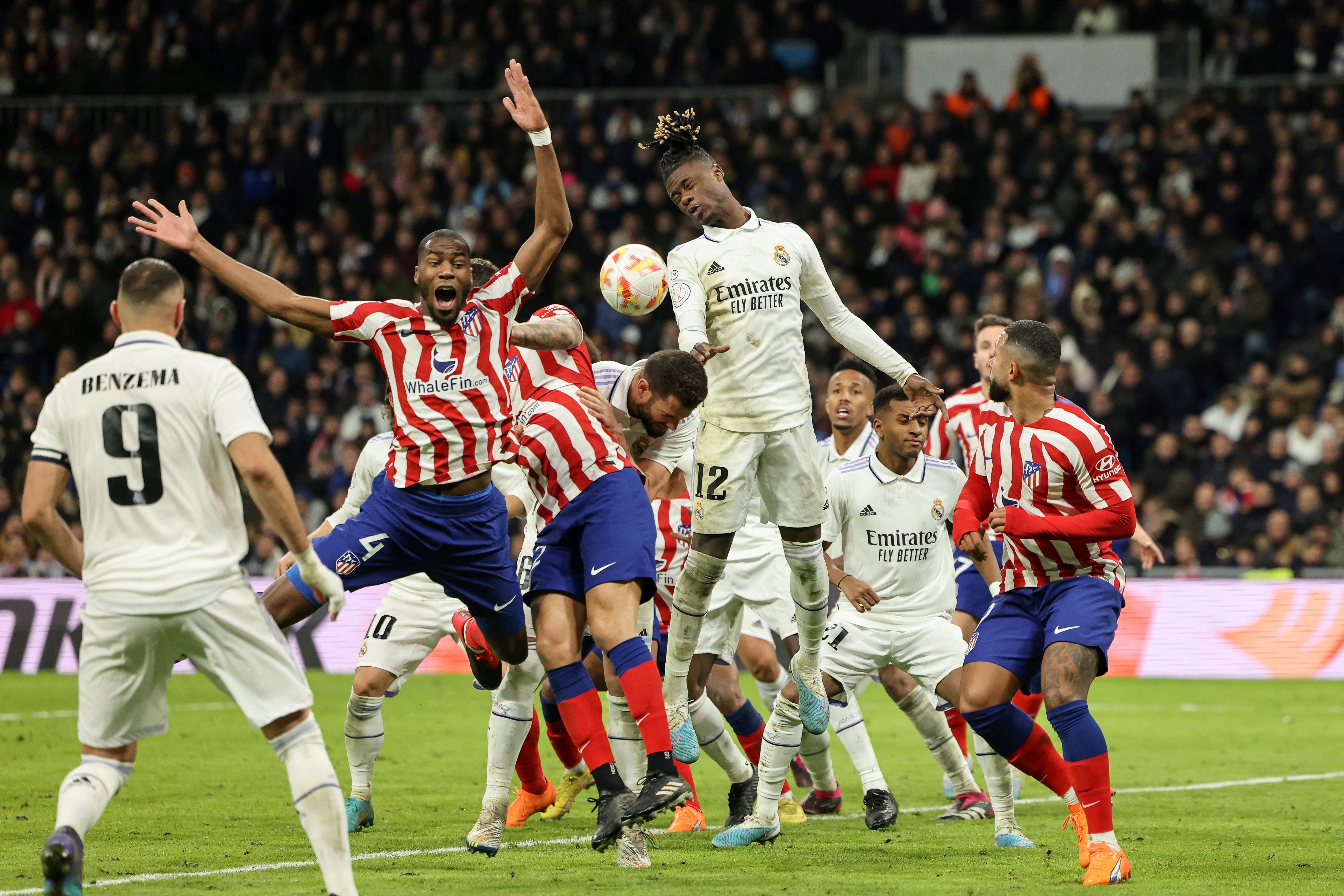 Atletico Madrid’s French midfielder Geoffrey Kondogbia (L) and Real Madrid’s French midfielder Eduardo Camavinga (C) jump for the ball during the Copa del Rey (King’s Cup), quarter final football match between Real Madrid CF and Club Atletico de Madrid at the Santiago Bernabeu stadium in Madrid on January 26, 2023.
