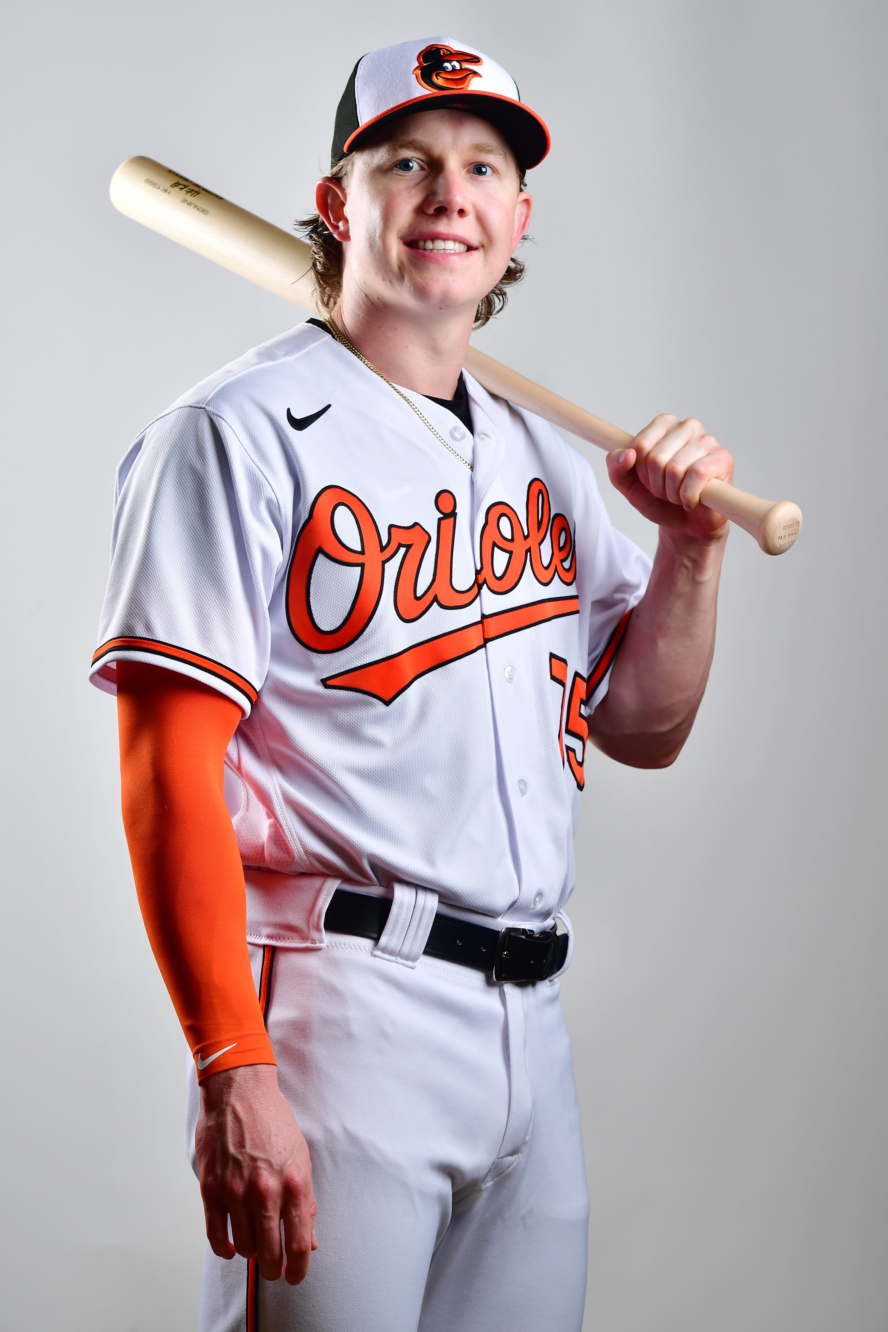 Orioles prospect Heston Kjerstad, wearing home whites, holding a baseball bat