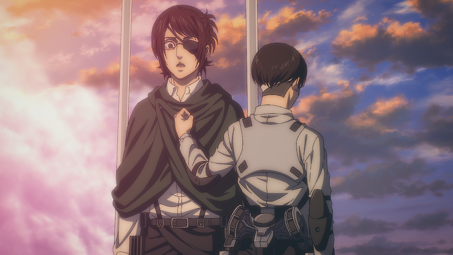 Hange Zoë from Attack on Titan stands looking upset while another character comforts them