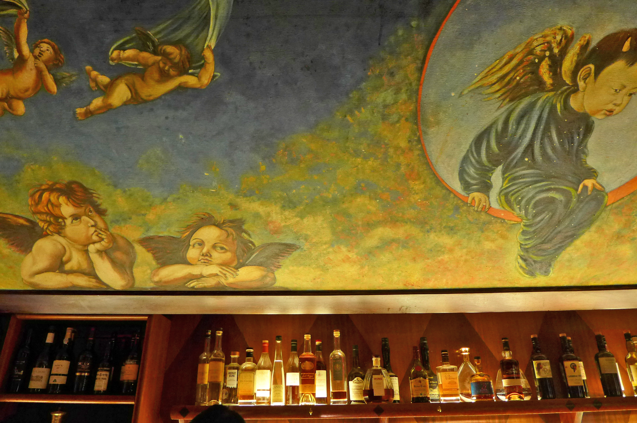 A huge, celestial painting with winged cherubs hangs above the bar at Angel’s Share.