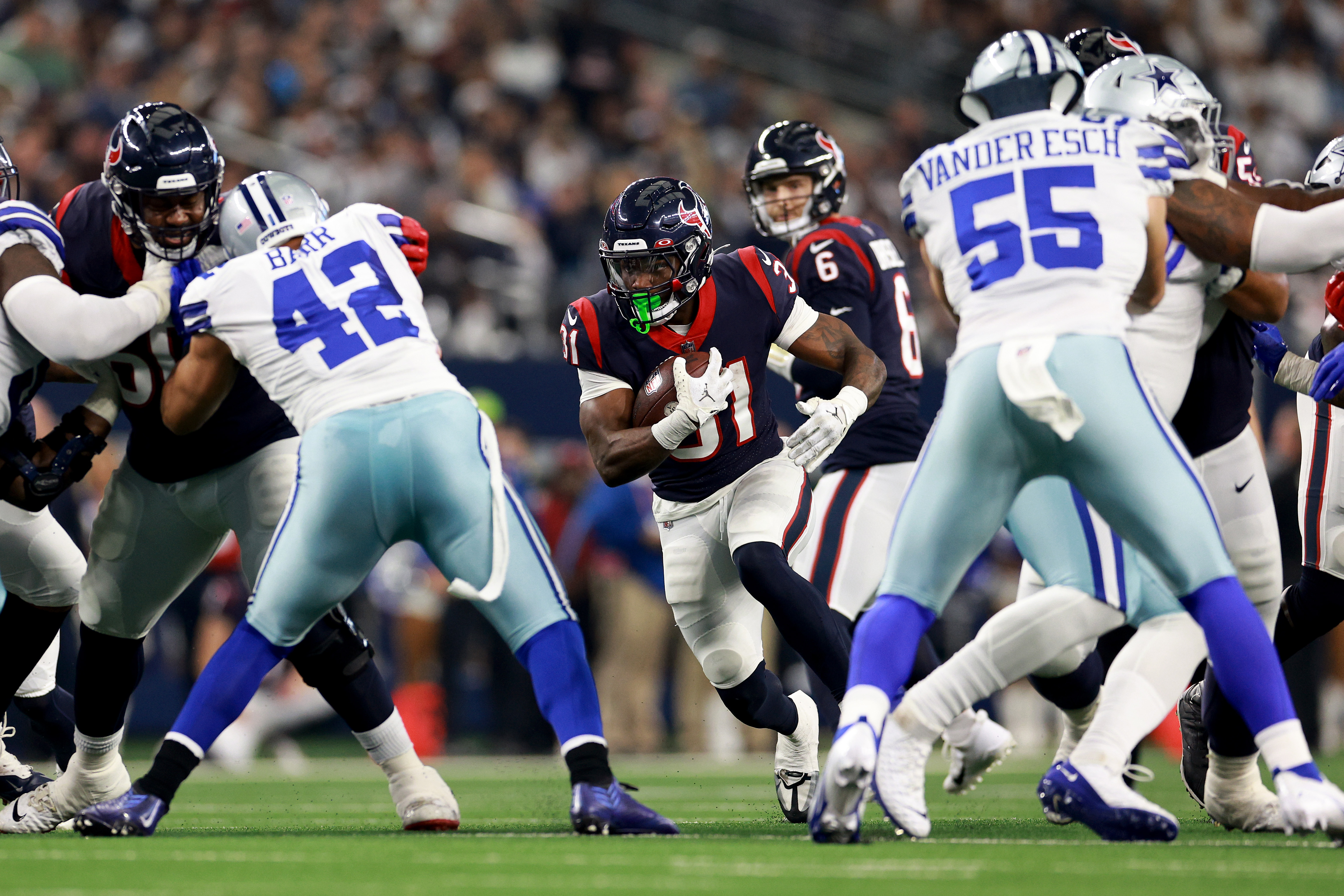 Dameon Pierce of the Houston Texans runs the ball during the first quarter against the Dallas Cowboys at AT&amp;T Stadium on December 11, 2022 in Arlington, Texas.