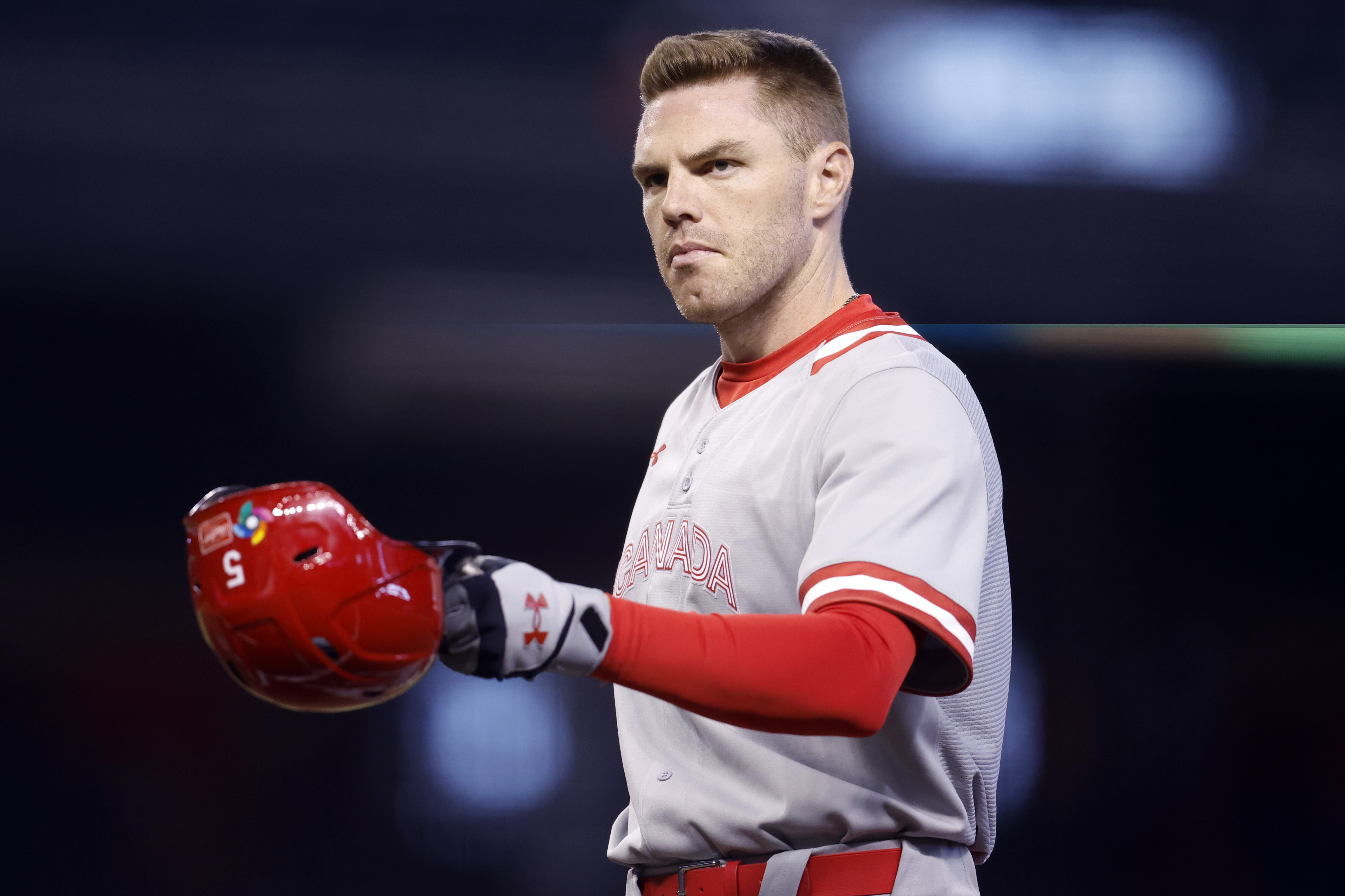 Freddie Freeman #5 of Team Canada removes his batting helmet after the final out in the second inning of the World Baseball Classic Pool C game against Team Colombia at Chase Field on March 14, 2023 in Phoenix, Arizona.