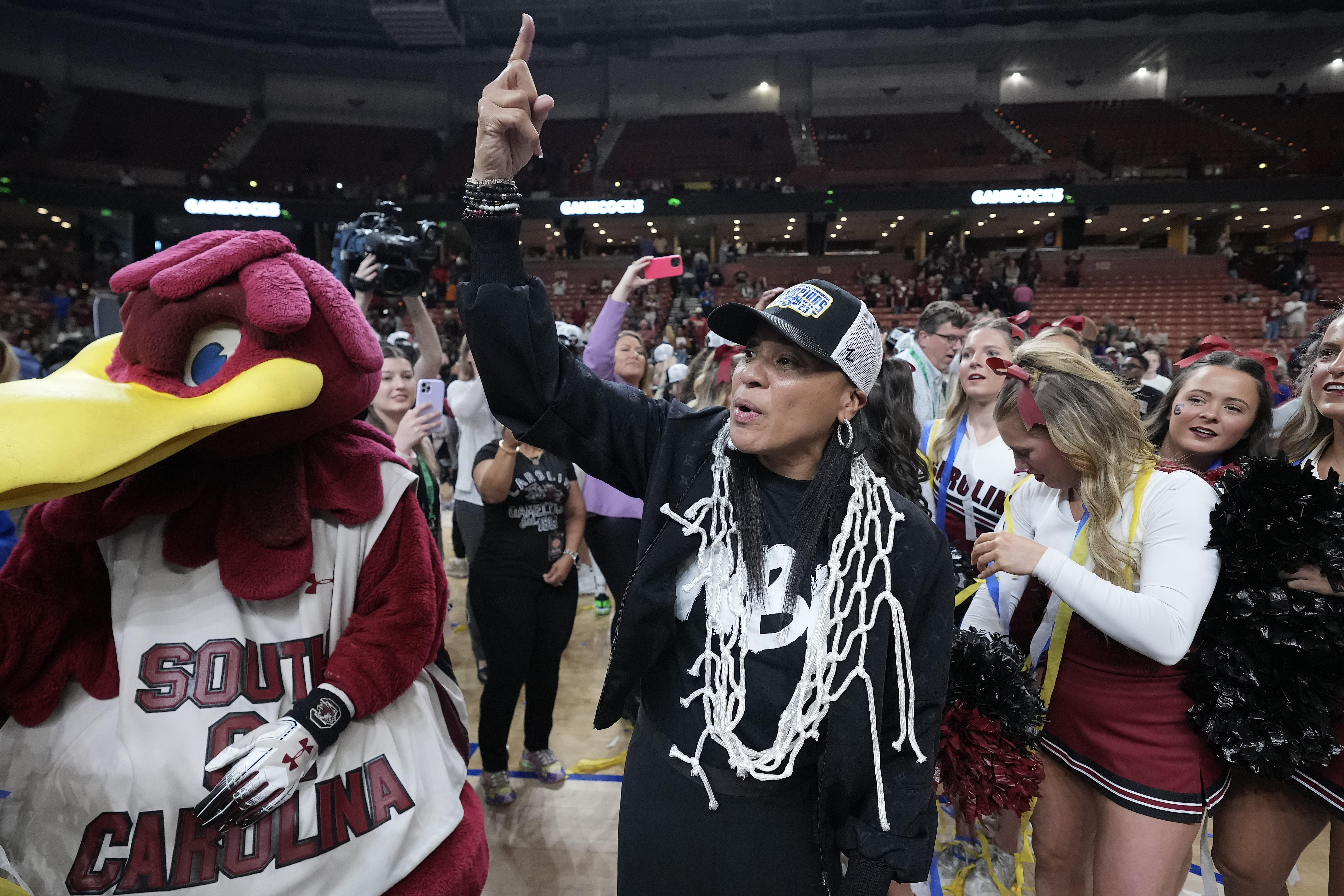 South Carolina Gamecocks head coach Dawn Staley wears the net rounder neck and flashes a number on to the crowd after winning the SEC Championship at Bon Secours Wellness Arena.