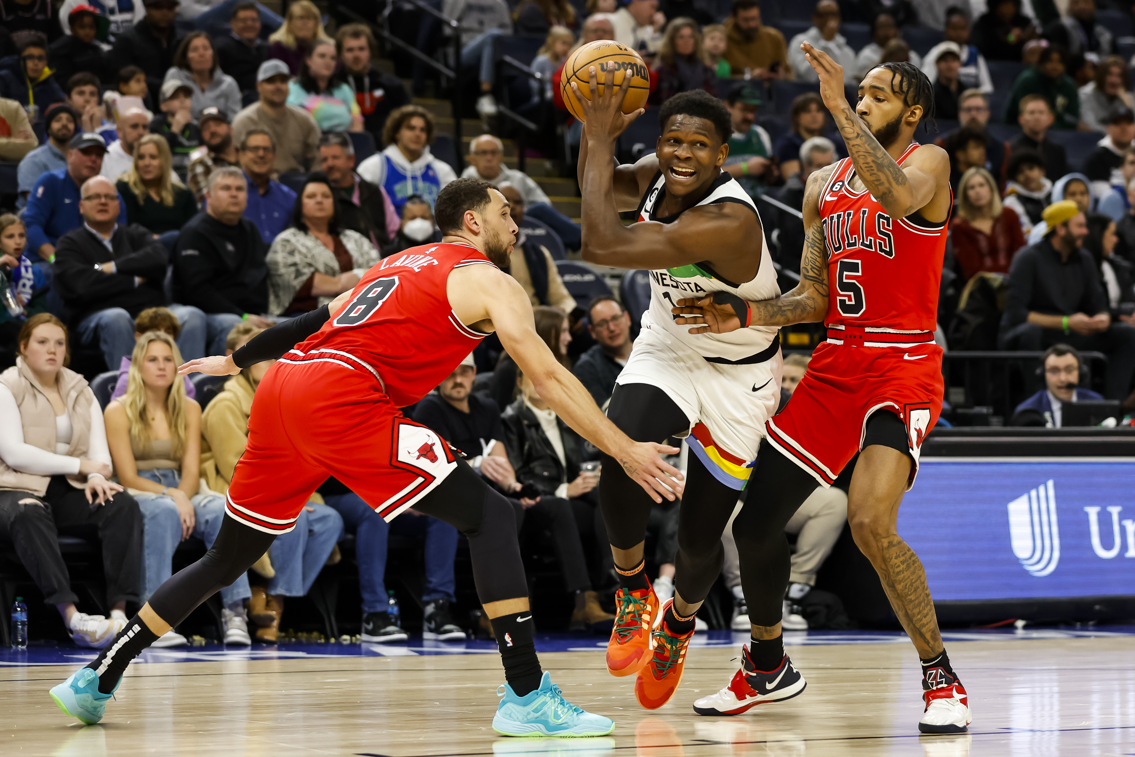 Anthony Edwards of the Minnesota Timberwolves drives to the basket while Zach LaVine and Derrick Jones Jr. of the Chicago Bulls defend in the first quarter of the game at Target Center on December 18, 2022 in Minneapolis, Minnesota. The Timberwolves defeated the Bulls 150-126. 