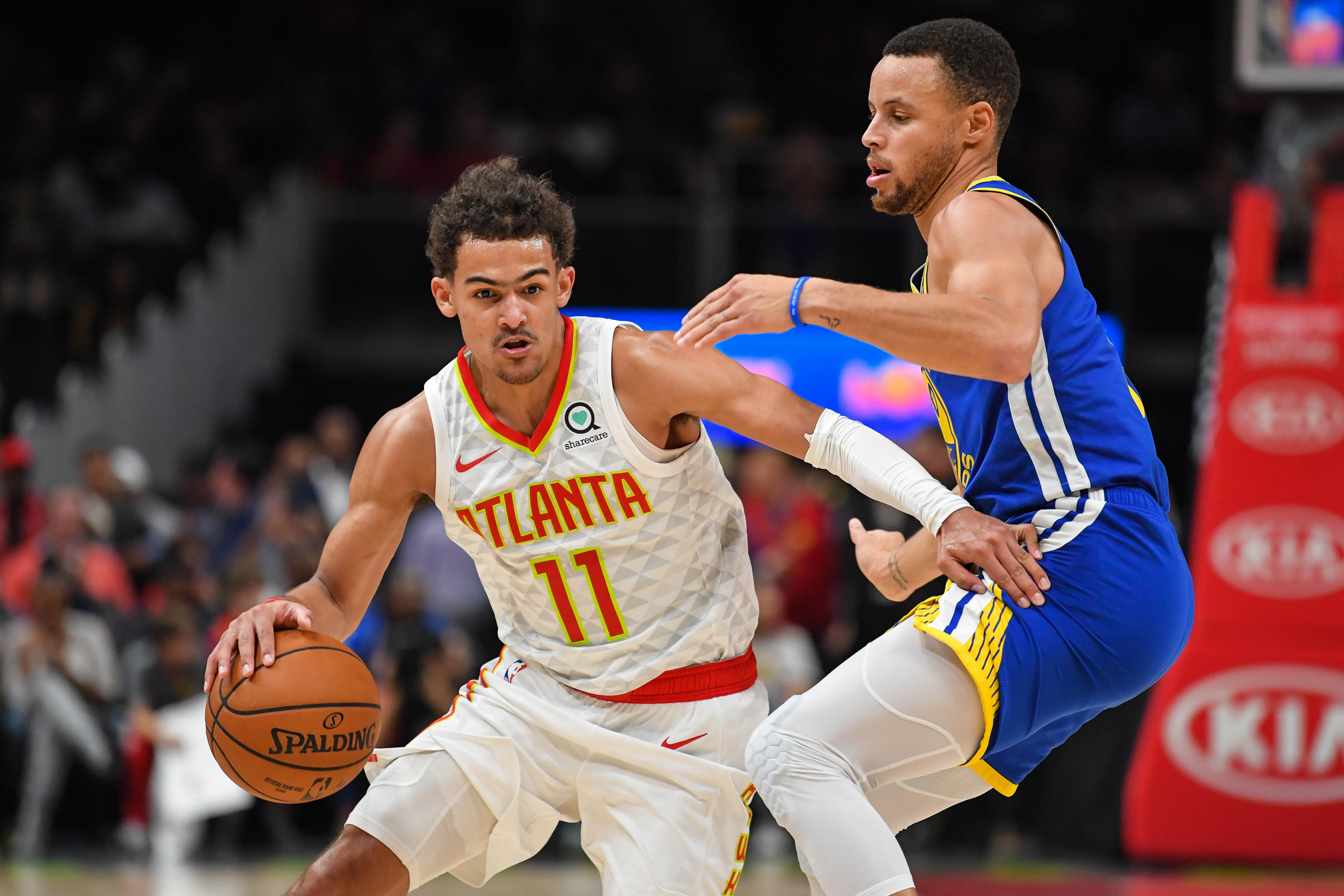 Atlanta Hawks guard Trae Young (11) works against Golden State Warriors guard Stephen Curry (30) during the second half at State Farm Arena.