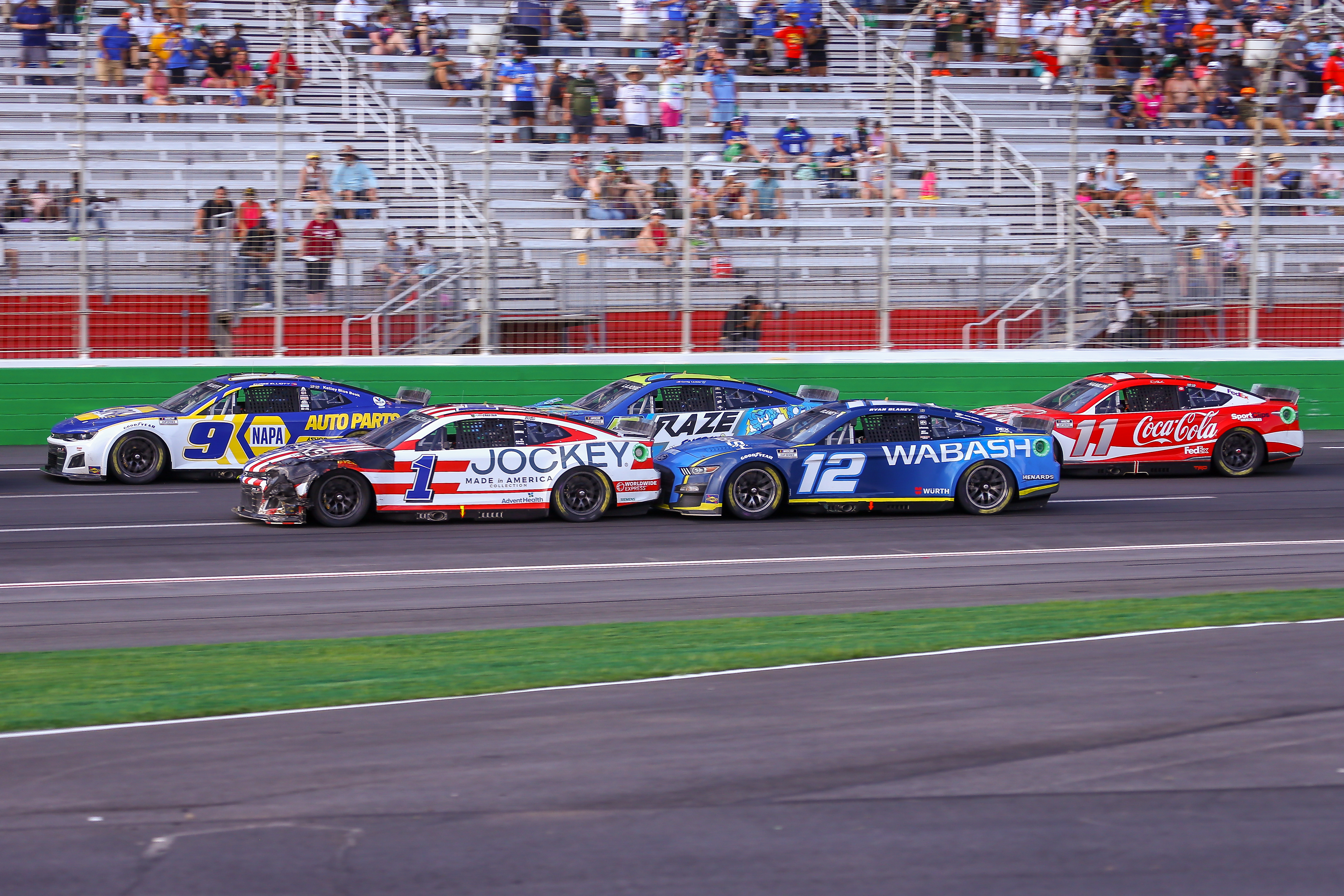 NASCAR Cup Series driver Chase Elliott (9), NASCAR Cup Series driver Ross Chastain (1), NASCAR Cup Series driver Ryan Blaney (12), NASCAR Cup Series driver Corey LaJoie (7), and NASCAR Cup Series driver Denny Hamlin (11) race in close quarters during the Quaker State 400 Presented by Walmart on July 10, 2022 at Atlanta Motor Speedway in Atlanta, GA.