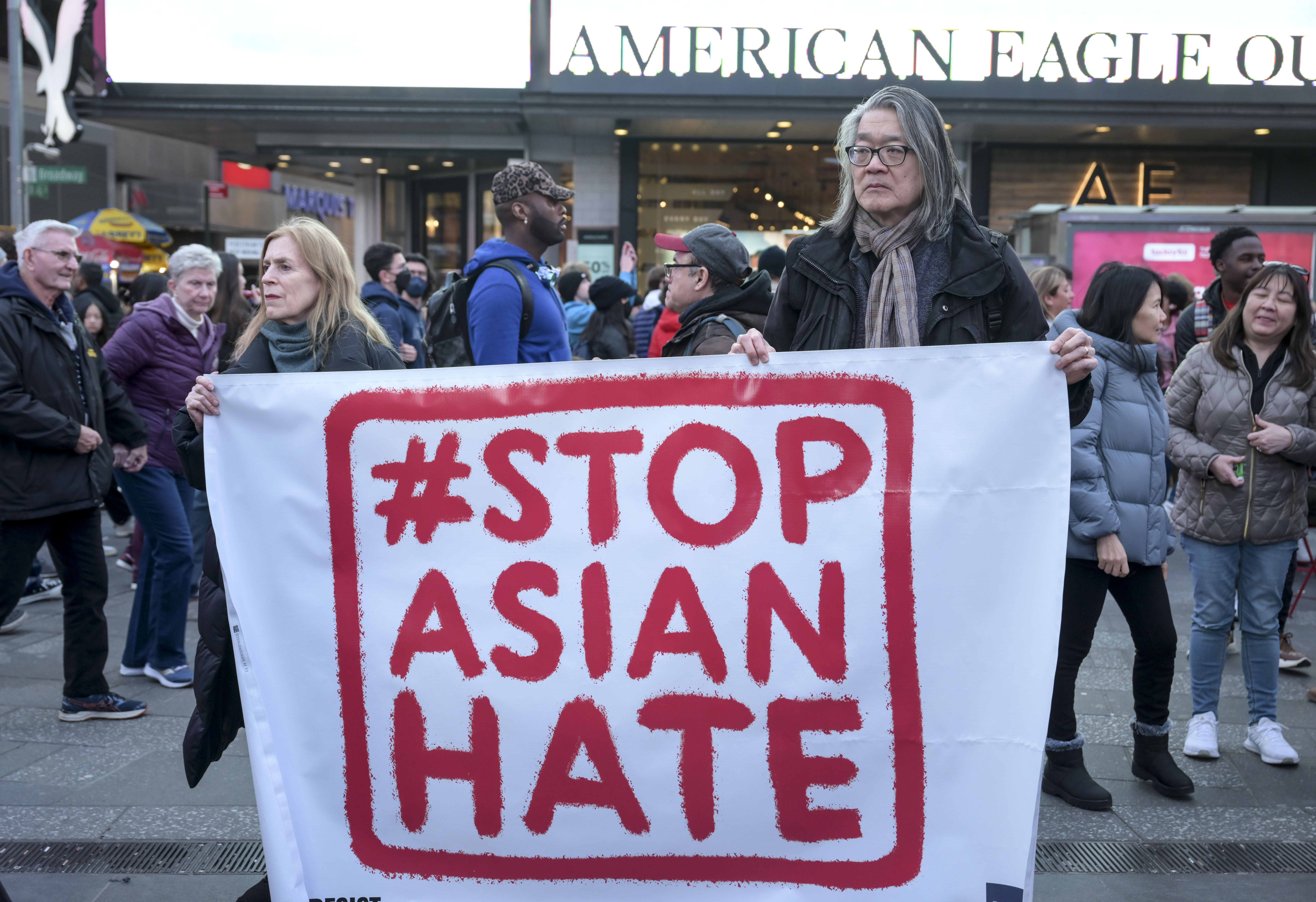 Protestors hold a sign reading “#STOP ASIAN HATE”