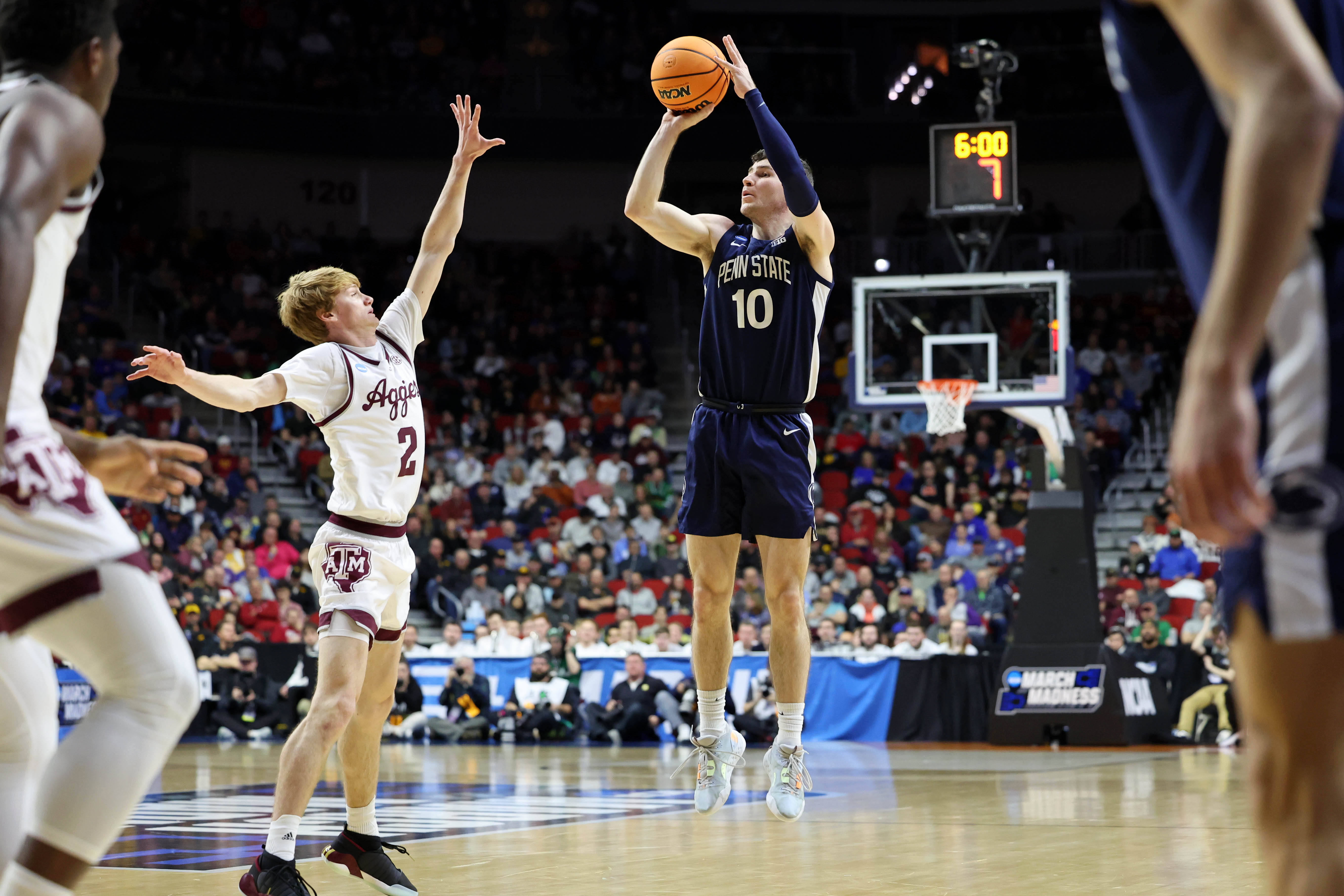 Penn State Nittany Lions guard Andrew Funk (10) shoots the ball against Texas A&amp;amp;M Aggies guard Hayden Hefner (2) during the first half at Wells Fargo Arena.