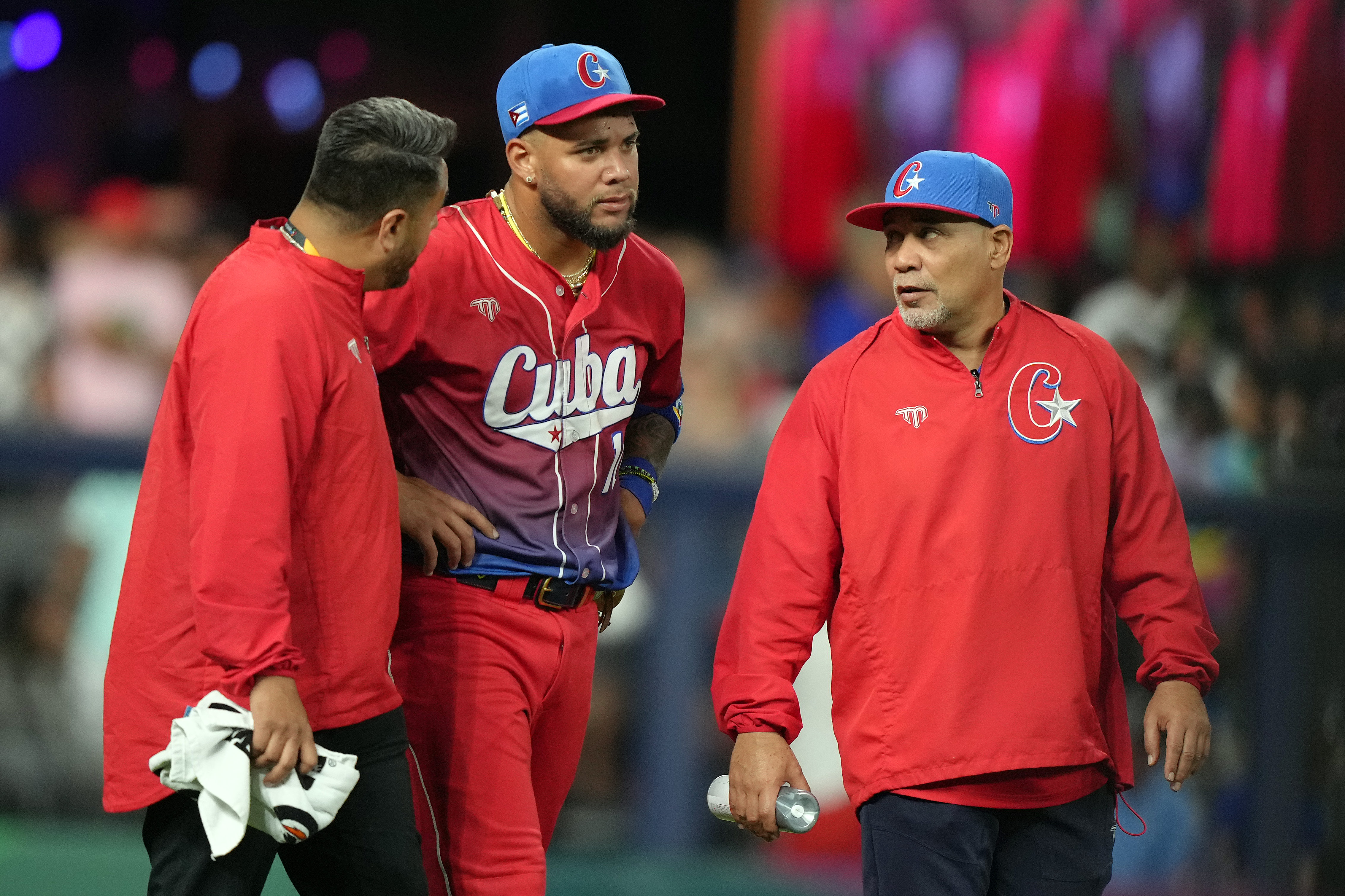 Yoan Moncada #10 of Team Cuba receives medical attention after colliding while trying to make a catch in the sixth inning against Team USA during the World Baseball Classic Semifinals at loanDepot park on March 19, 2023 in Miami, Florida.