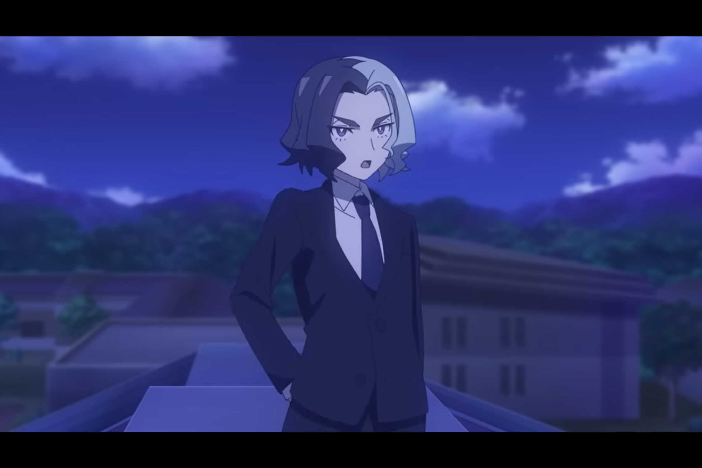 A person in a suit and tie with blue and white hair, split down the middle. From the Pokemon anime.